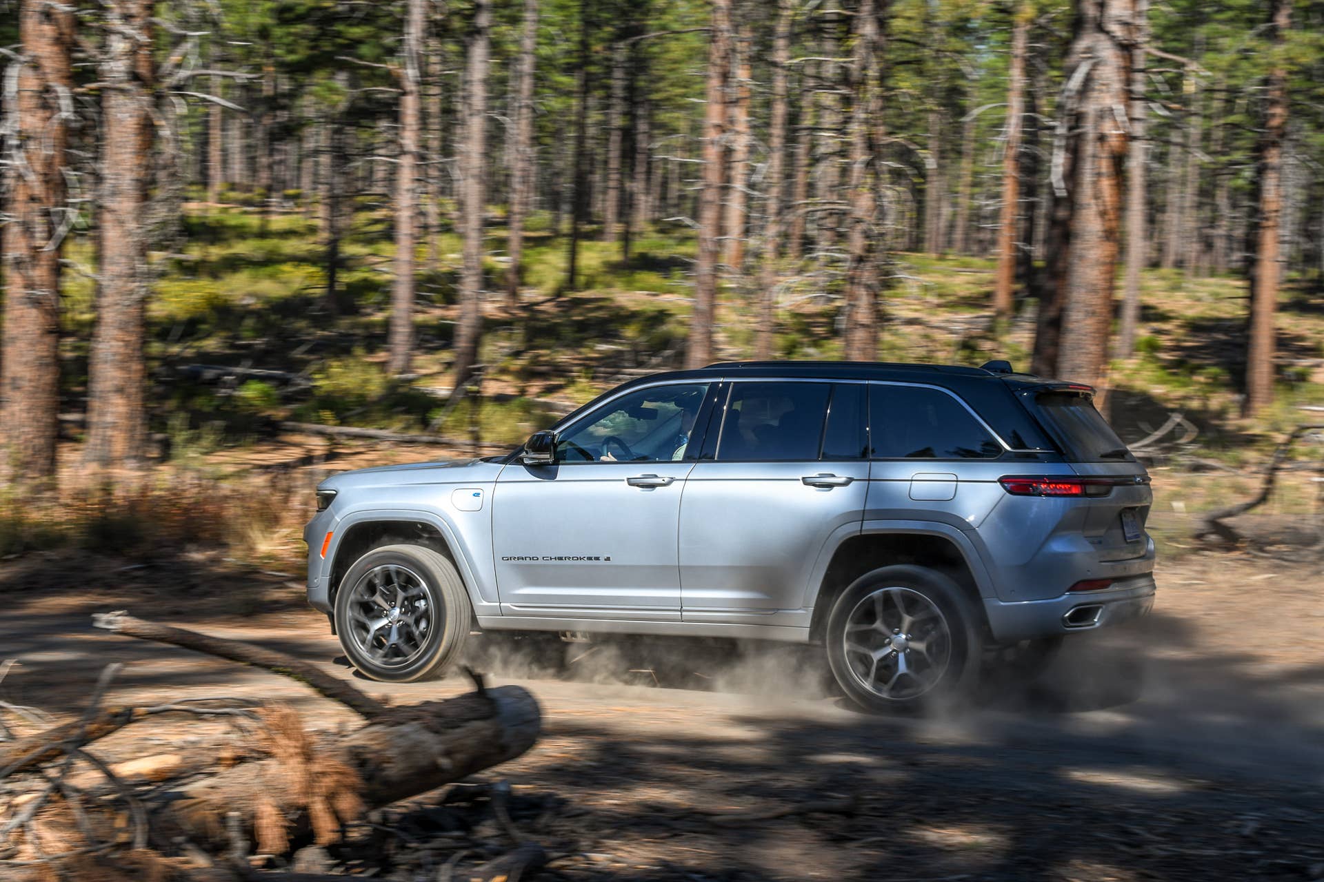 2025 Jeep Grand Cherokee 4xe Summit Reserve silver side view dirt driving