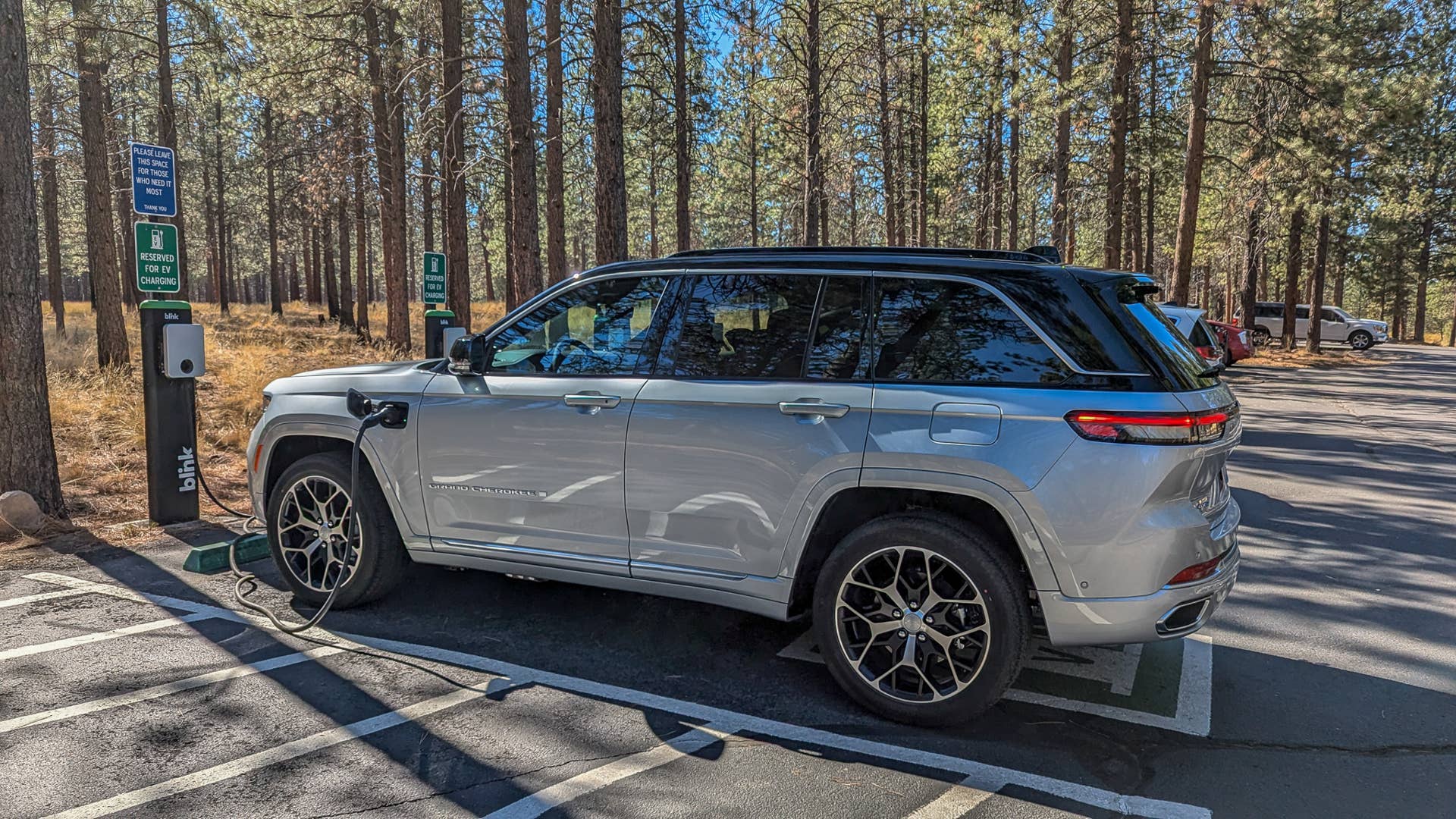 The 2025 Jeep Grand Cherokee 4xe Summit Reserve plugged into a public charger
