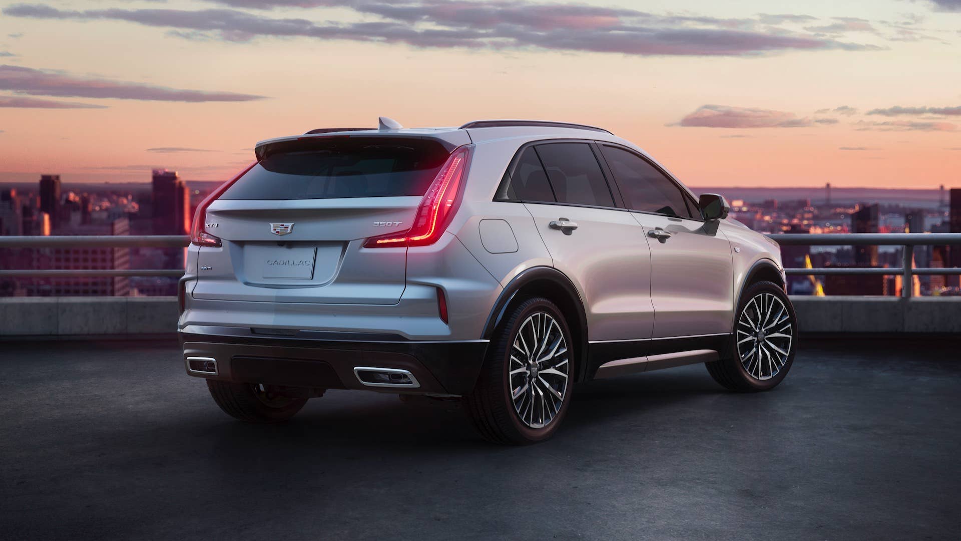 Rear 3/4 shot of the 2025 Cadillac XT4 in Argent Silver Sport featuring the updated modern rear design and all-new available 20-inch alloy wheels.
