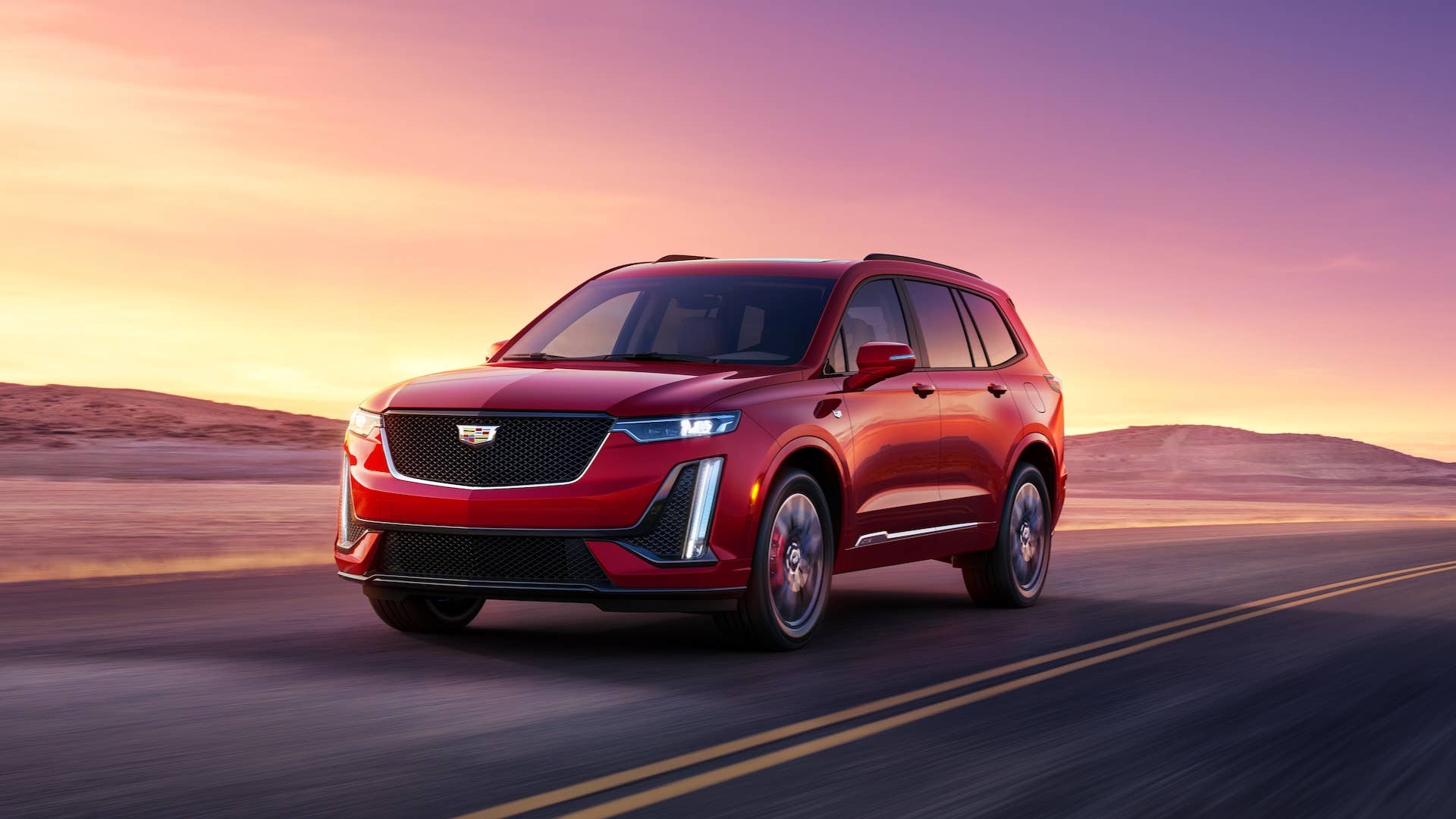 Driving shot of the 2025 Cadillac XT6 Sport highlights its bold, modern look.