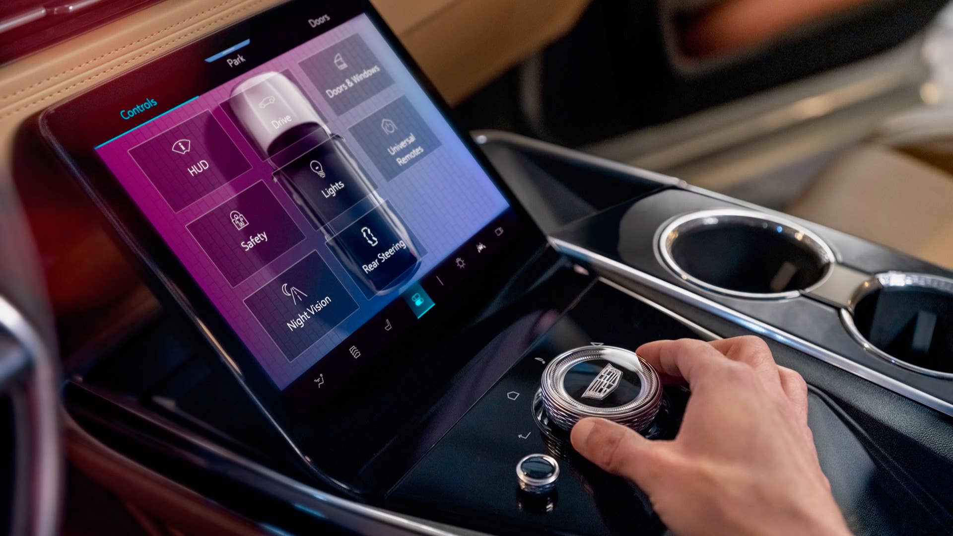 Close-up of man using control console in Cadillac ESCALADE IQ Sport.