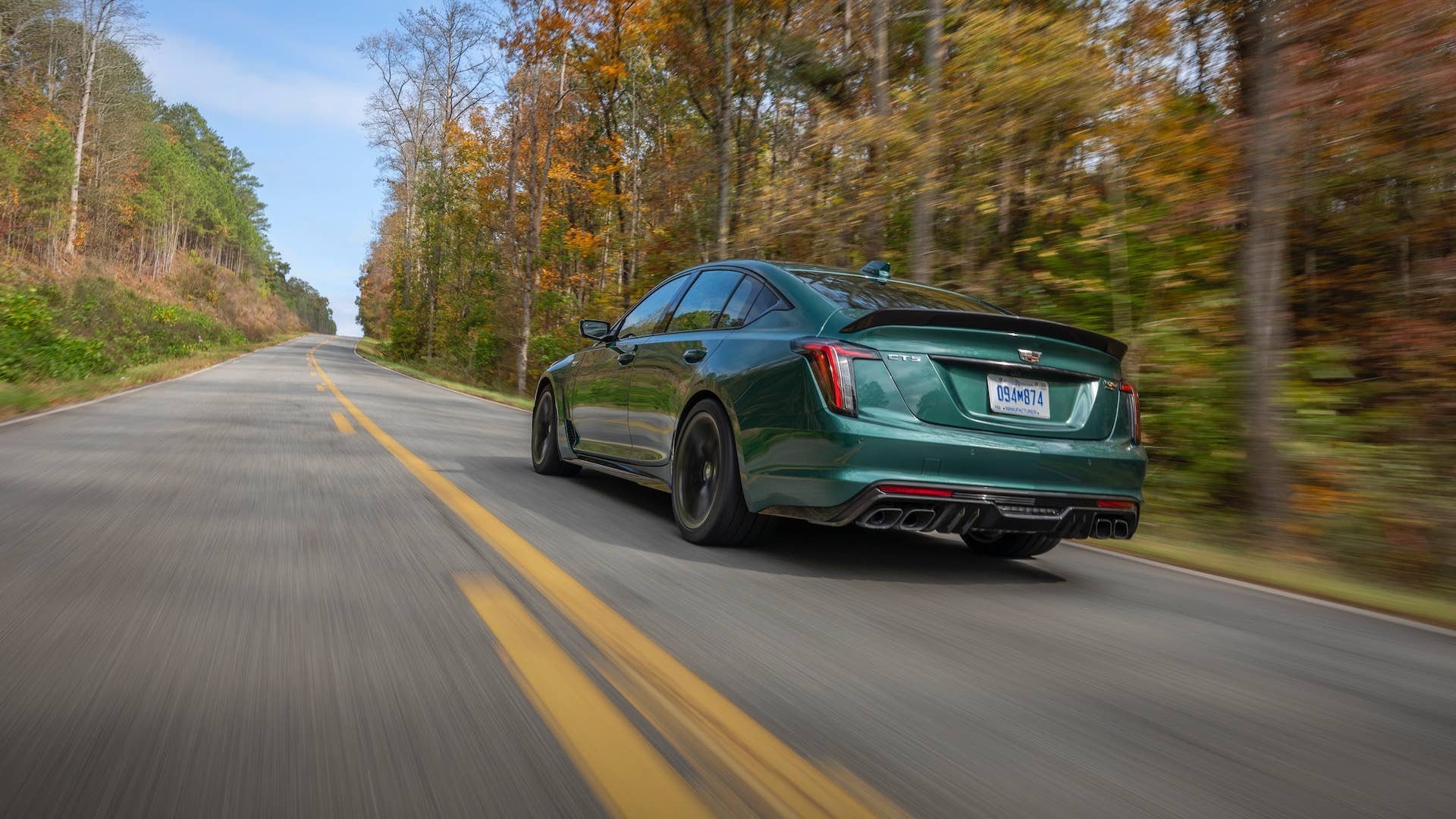 Rear view of the 2026 Cadillac CT5-V Blackwing Precision Package in Typhoon Metallic driving on a road.