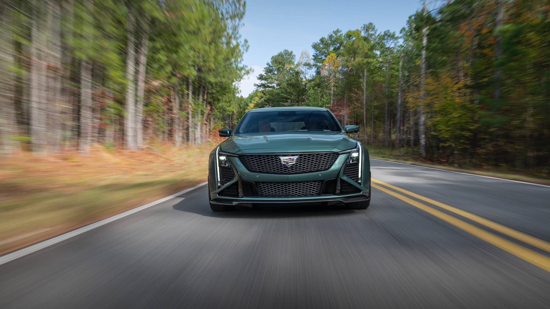 Front view of the 2026 Cadillac CT5-V Blackwing Precision Package in Typhoon Metallic driving on a road.