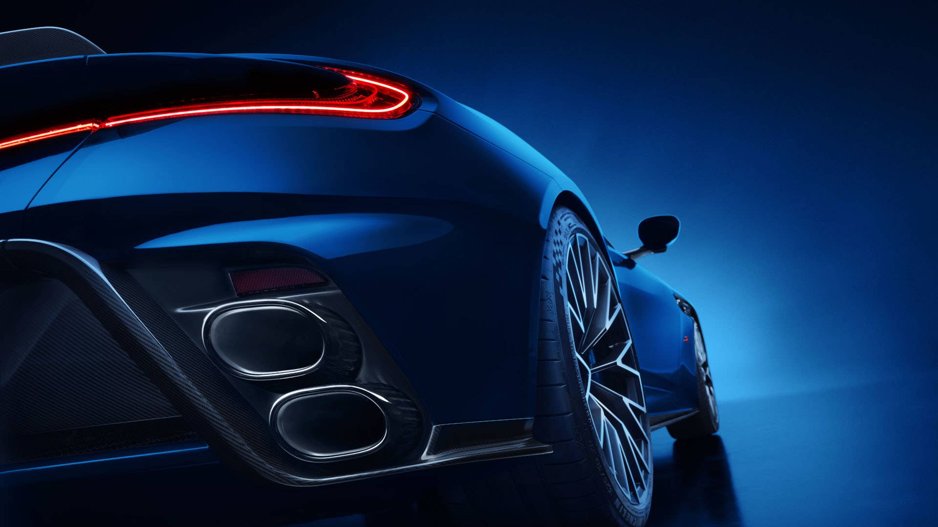 2026 Aston Martin DB12 S Coupe in blue low rear angled exhaust view closeup