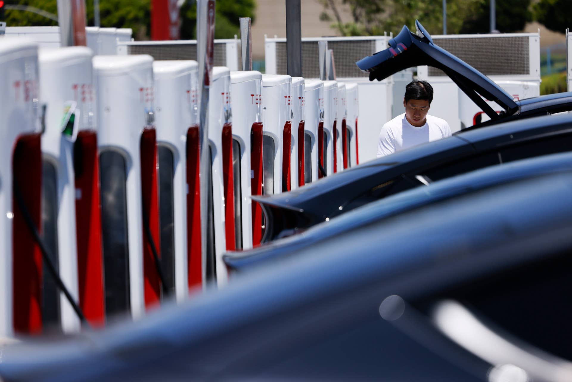 Hawthorne, CA – July 06: A man charges his Tesla at a Tesla Supercharger station on Sunday, July 6, 2025 in Hawthorne, CA. (Carlin Stiehl / Los Angeles Times via Getty Images)

