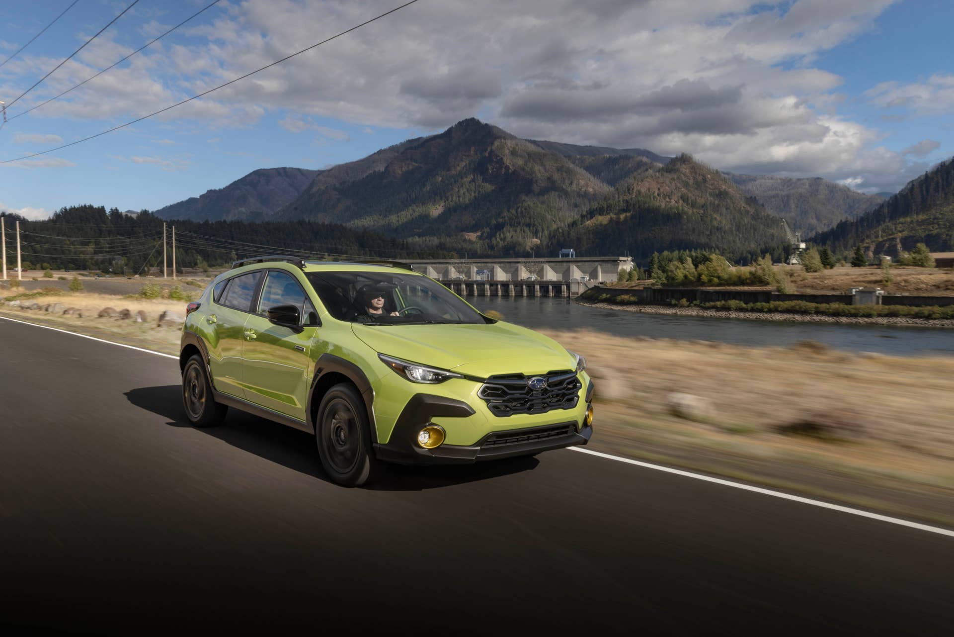 2026 Subaru Crosstrek Hybrid Limited in Citron Yellow Pearl front angled view driving