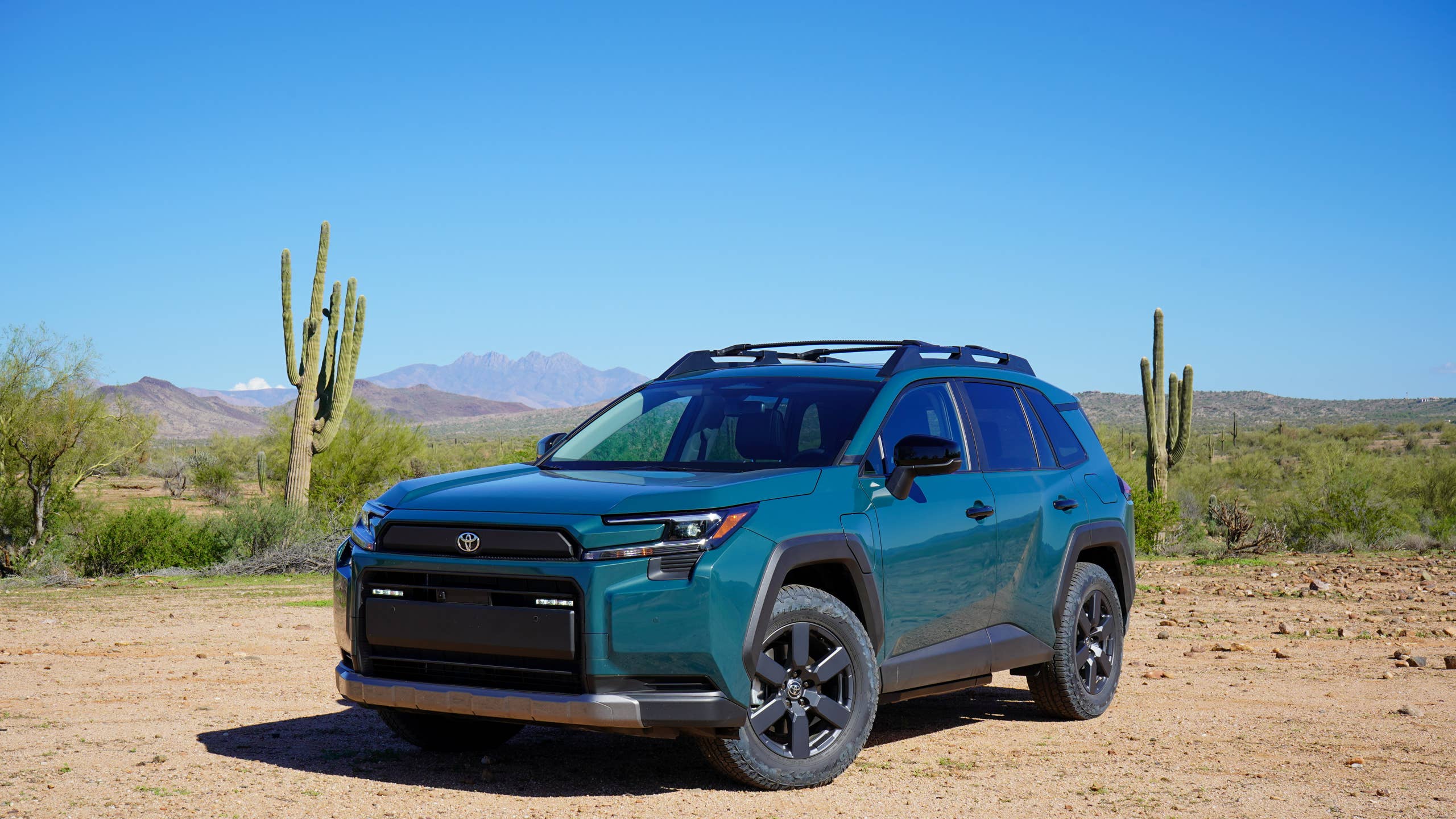 green 2026 toyota rav4 off-road suv in the desert on a sunny day