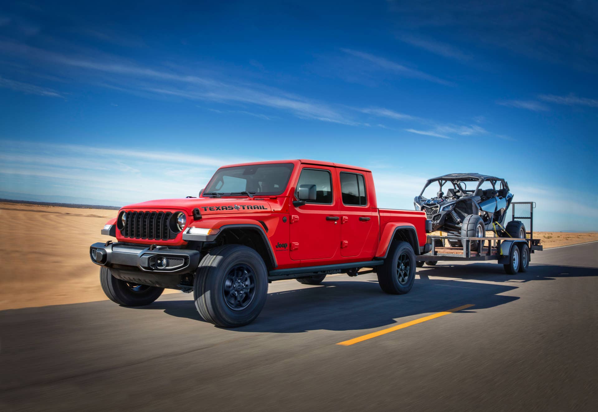 The 2025 Jeep Gladiator Texas Trail edition towing a dune buggy
