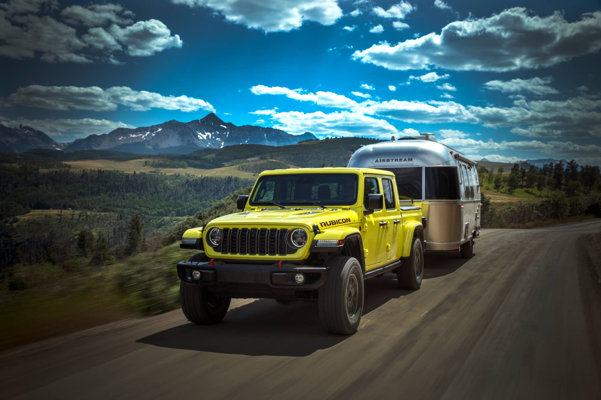 The Jeep Gladiator Rubicon X towing an airstream trailer down a highway