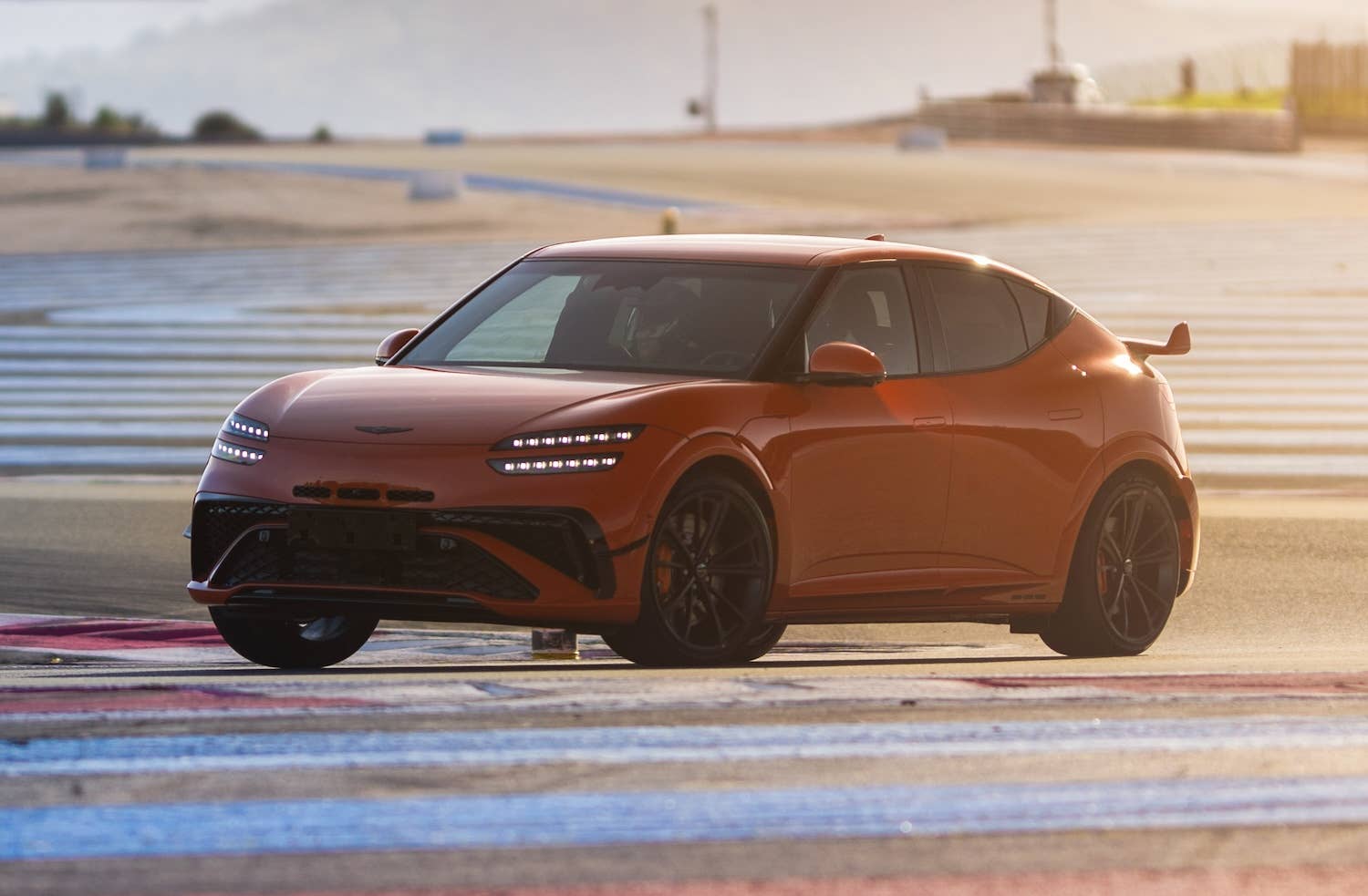 Genesis GV60 Magma front quarter on-track