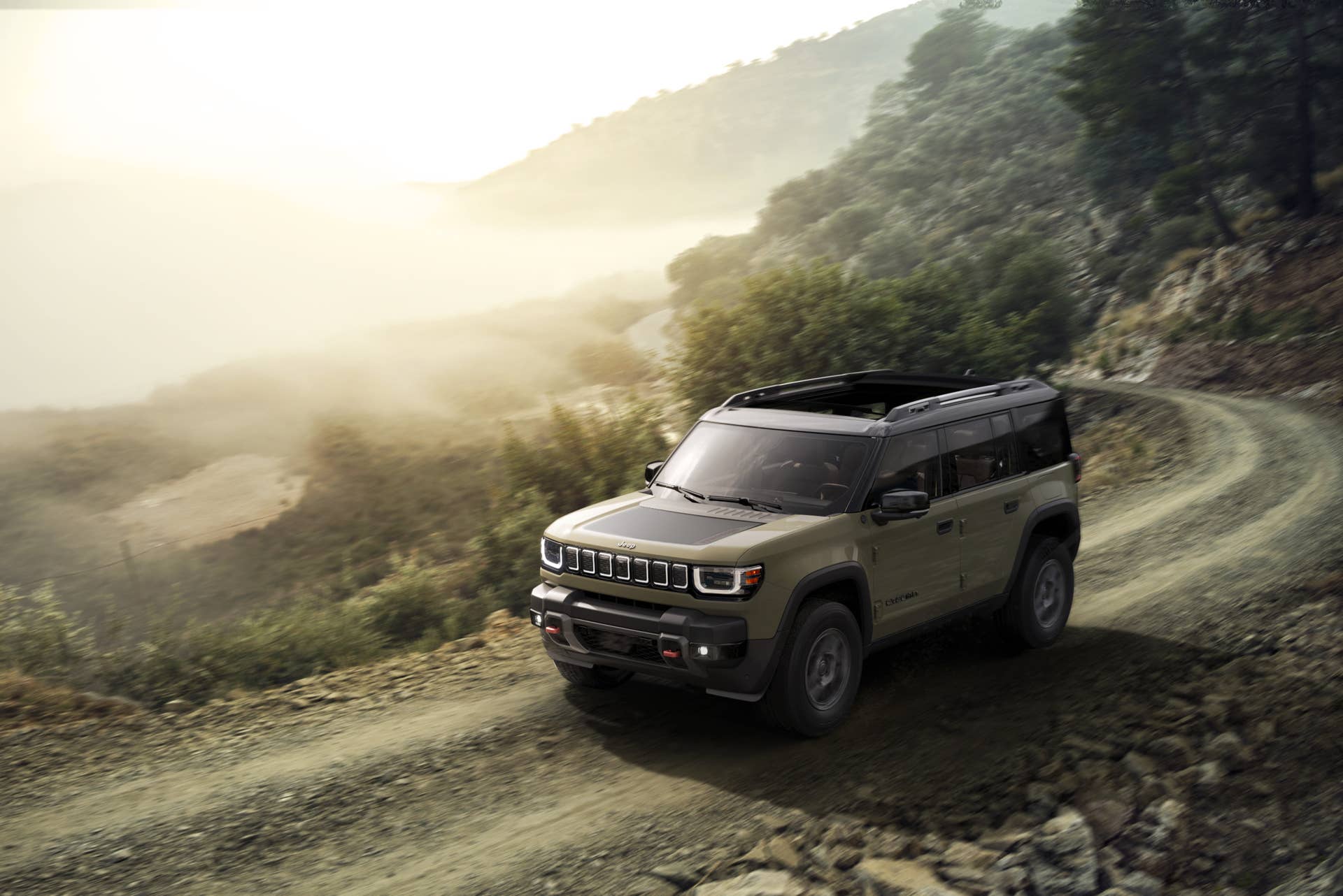 The new all-electric Jeep Recon driving along a gravel road