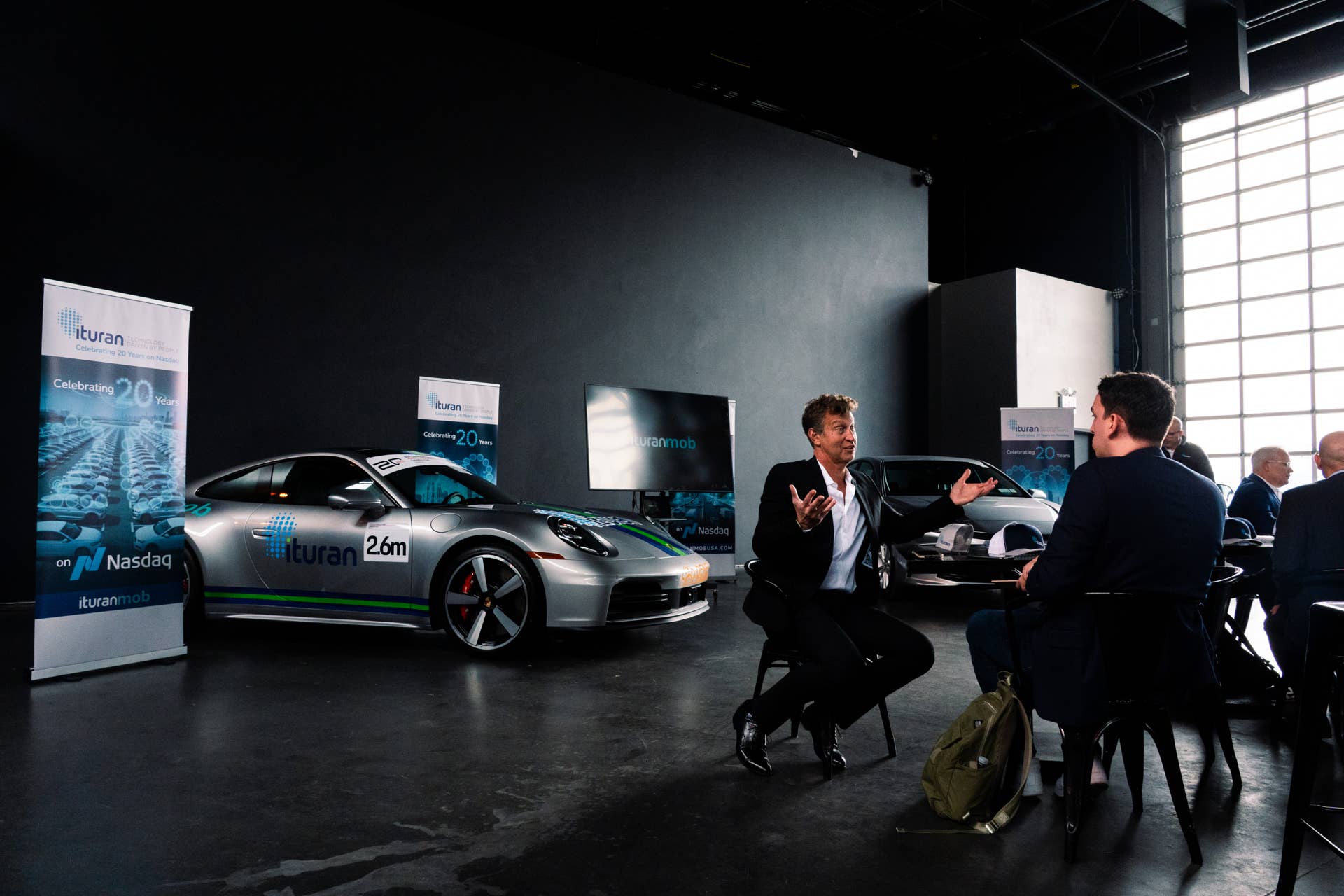 Ituran CEO Eyal Sheratzky (left) speaking with Cody Carlson of Autoblog (right)