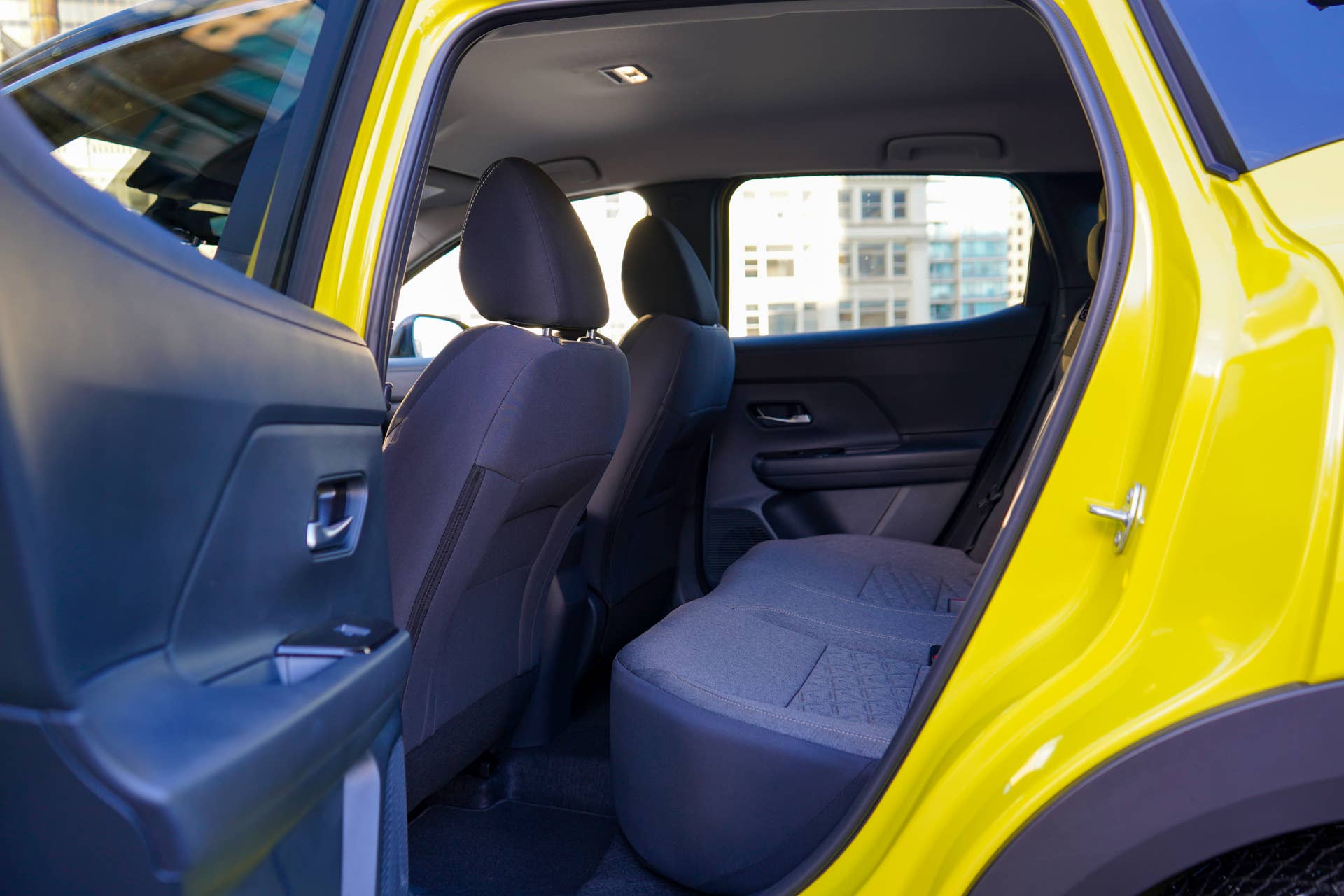 2026 Nissan Kicks SV AWD in Yuzu Yellow/black two-tone rear seats