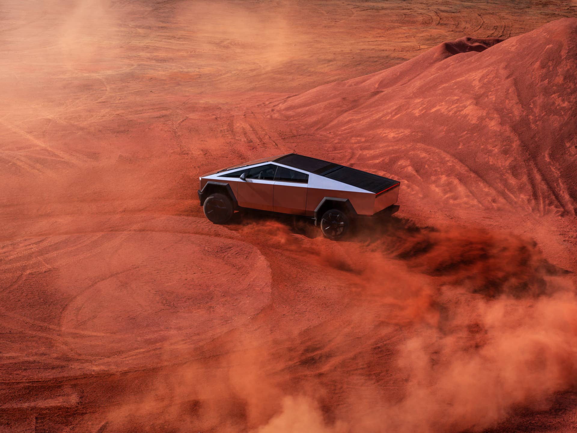 2026 Tesla Cybertruck overhead side view sand drifting