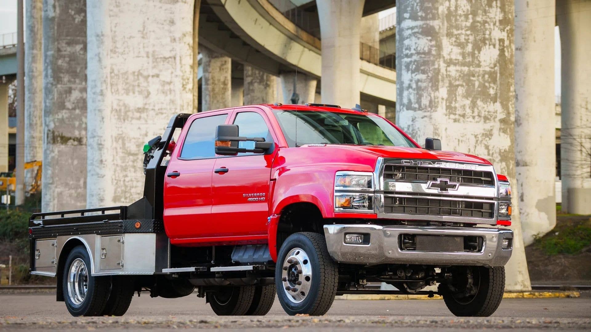 Red 2024 Chevrolet Silverado 4500HD Crew Cab 4×4 Flatbed Parked Front 3/4 View