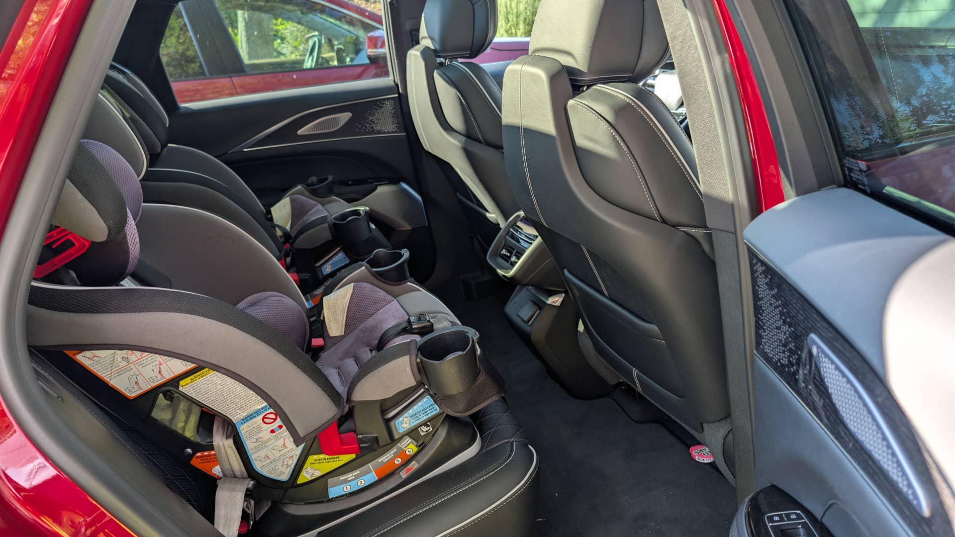 The rear seats of the 2026 Cadillac Lyriq-V with car seats installed