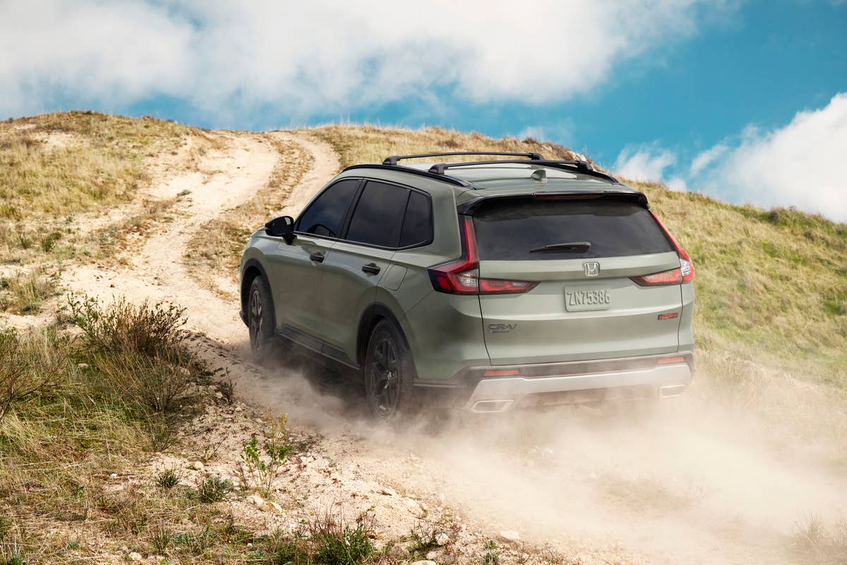 2026 Honda CR-V TrailSport in Ash Green rear angled view dirt driving