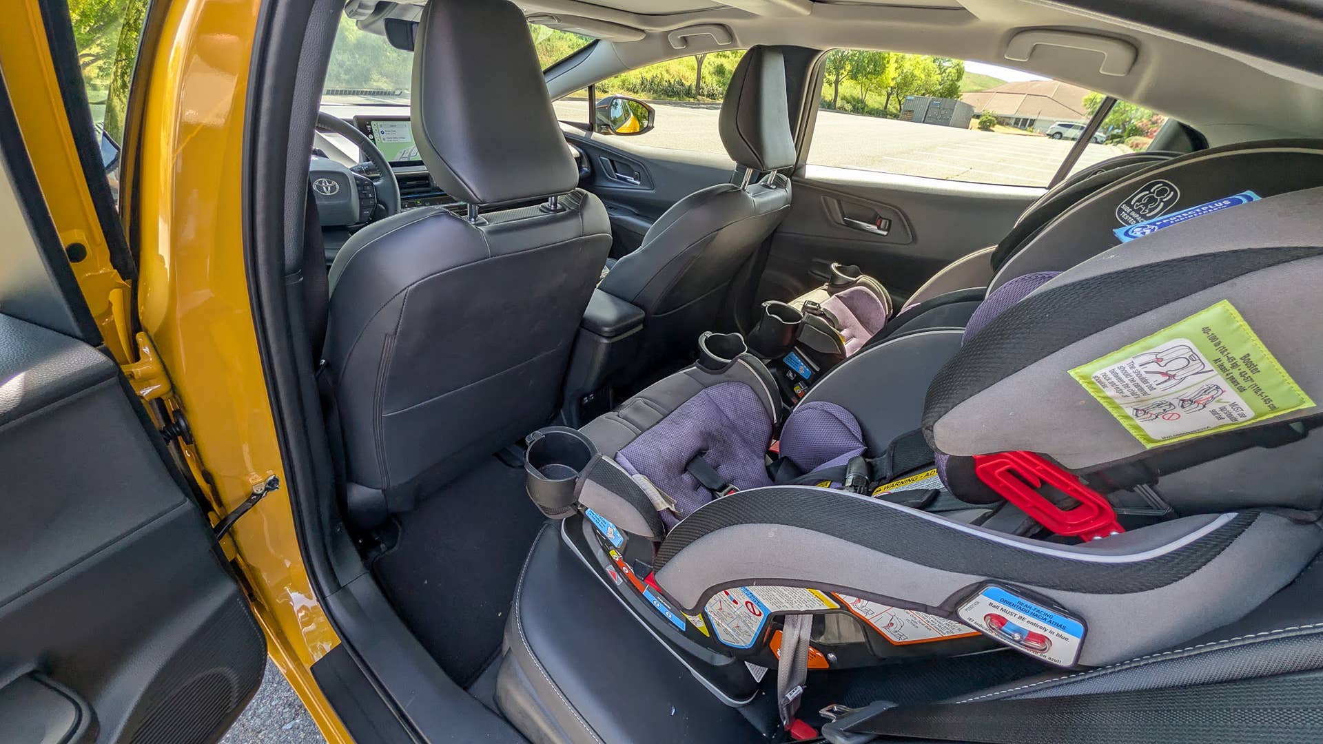 The rear seats of the 2026 Toyota Prius XSE Nightshade PHEV with car seats installed