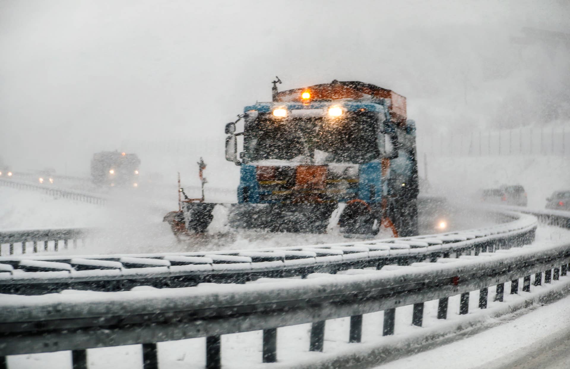 Snowplow plowing the highway during snow storm.