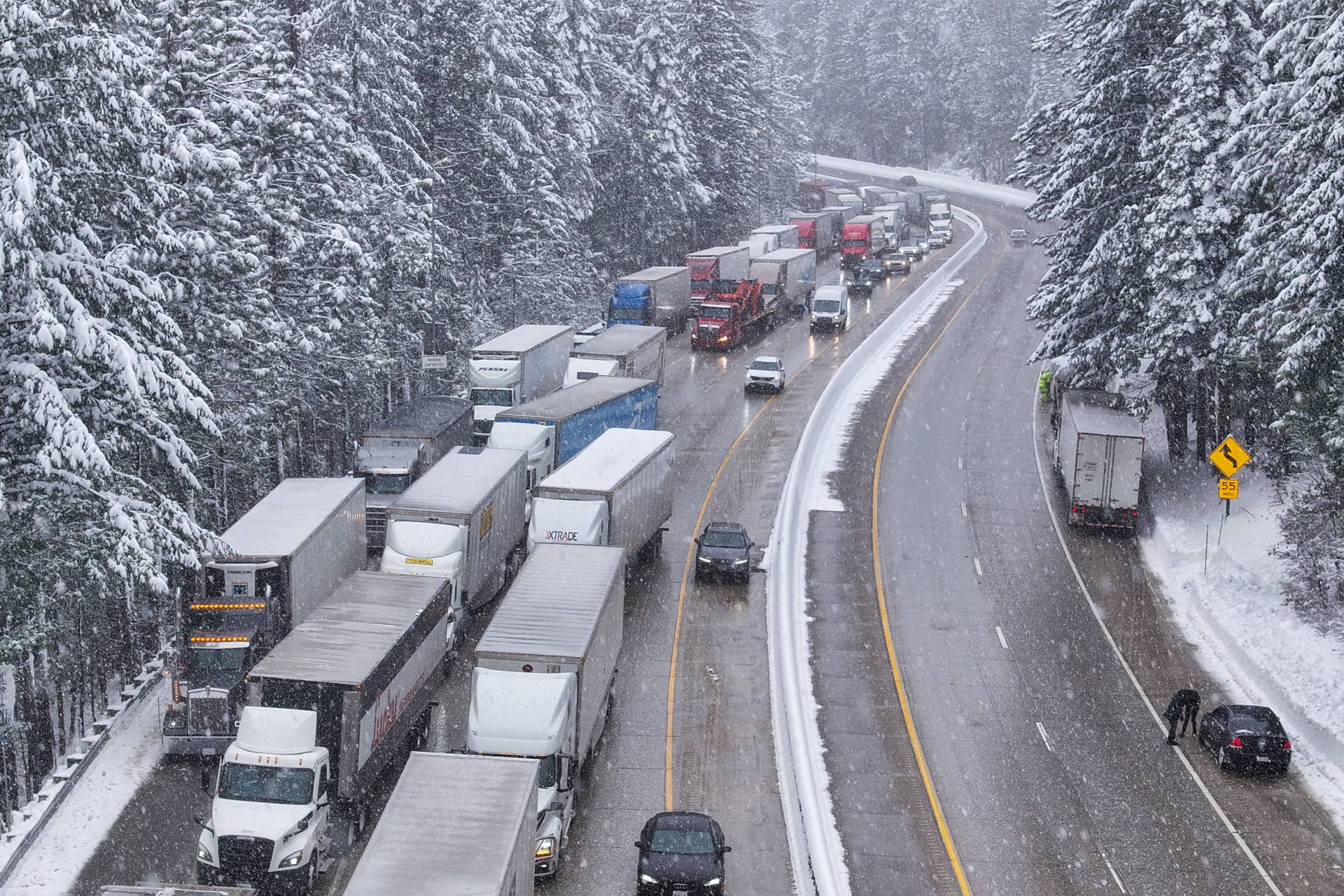 CALIFORNIA, UNITED STATES - MARCH 4: Hundreds of trucks line up for tire chain control on Highway I-80 Eastbound in Baxter, California, United States on March 4, 2024 as blizzard warning issued for California's Sierra Nevada. (Photo by Tayfun Coskun/Anadolu via Getty Images)