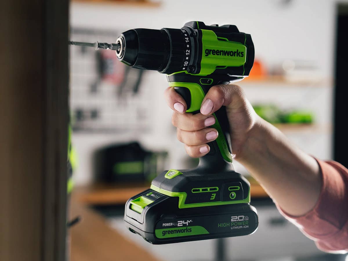A person uses a Greenworks drill
