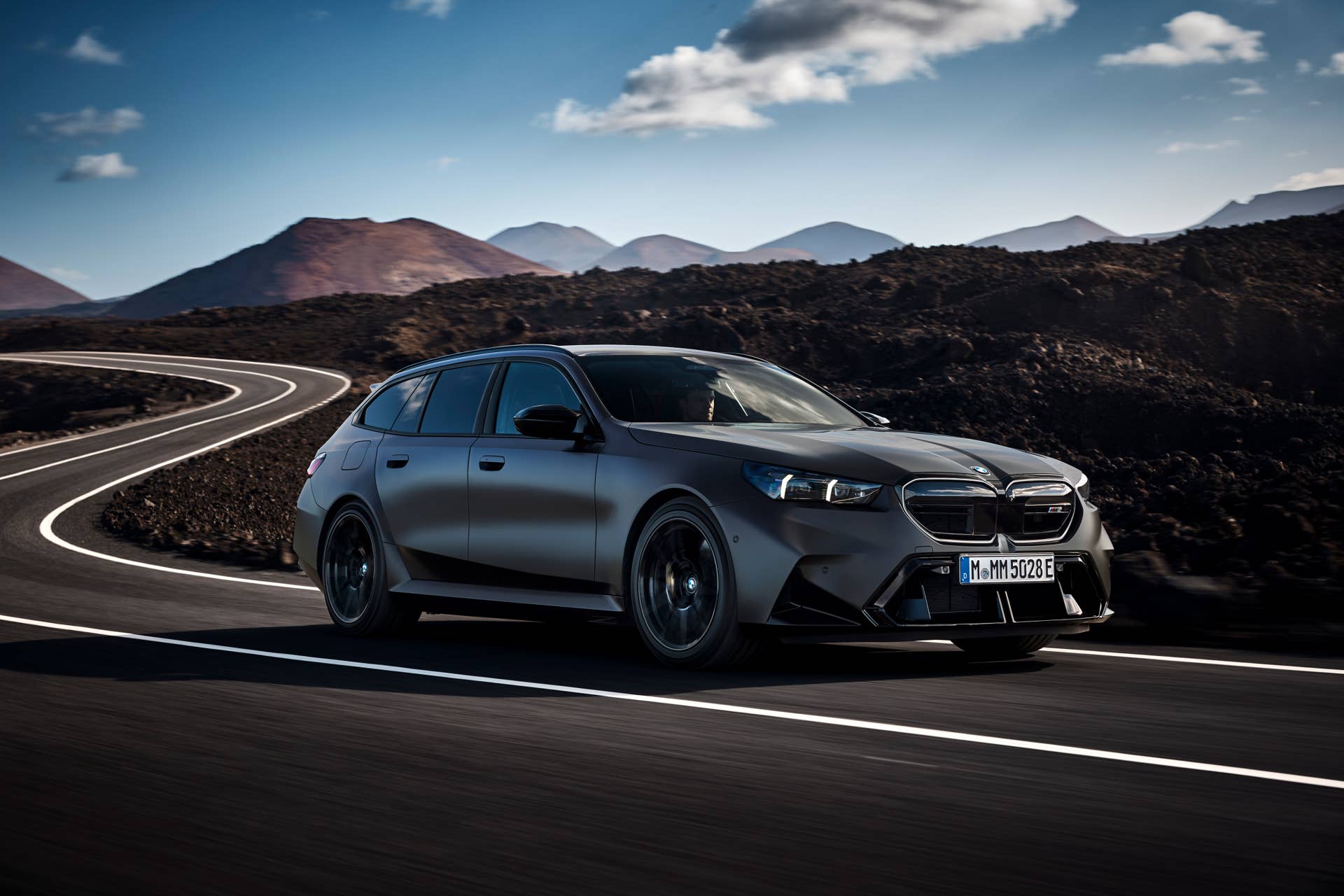 2026 BMW M5 Touring in BMW Individual Frozen Deep Grey front angled view driving