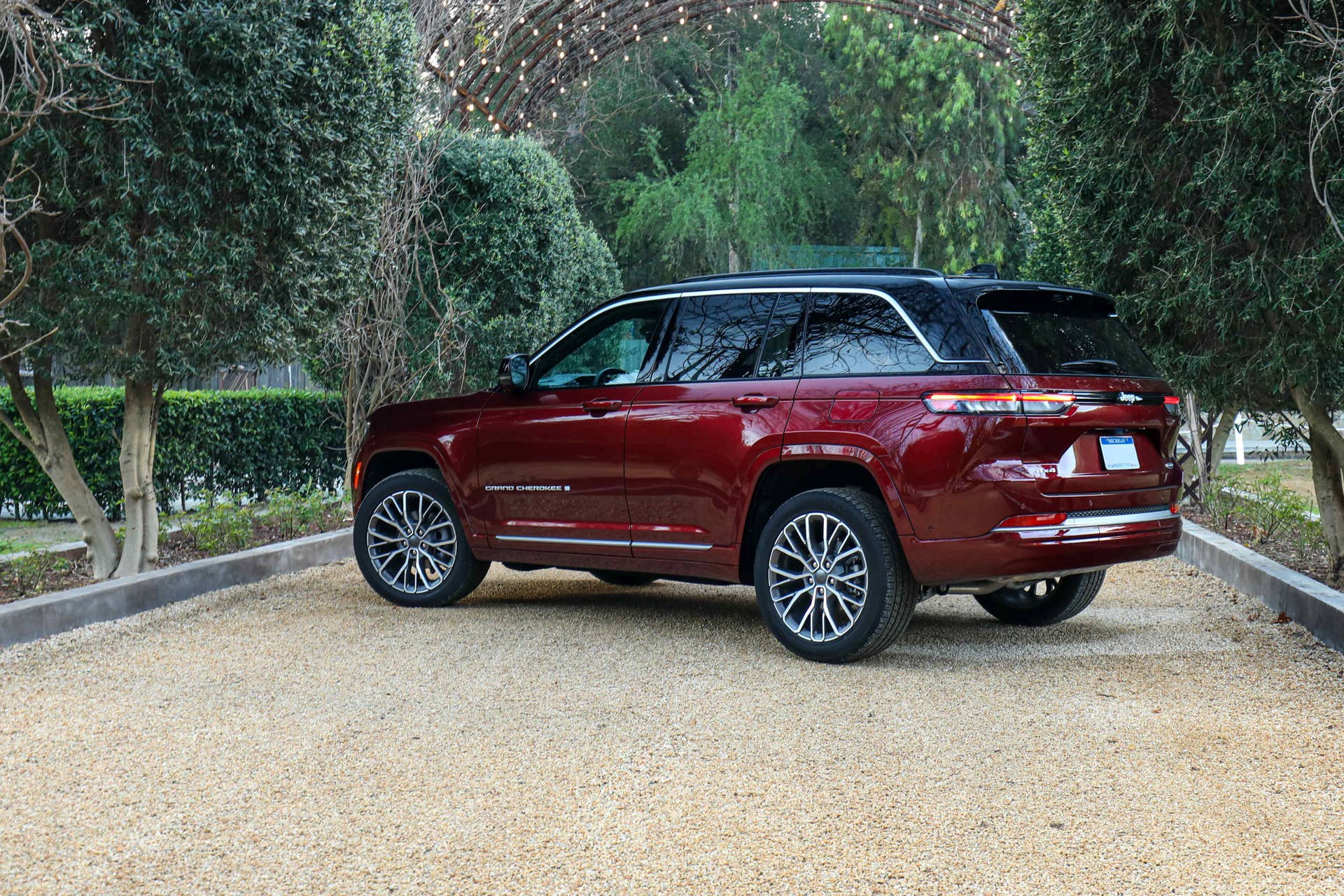 2026 Jeep® Grand Cherokee Summit in Velvet Red and black 2-tone rear angled view
