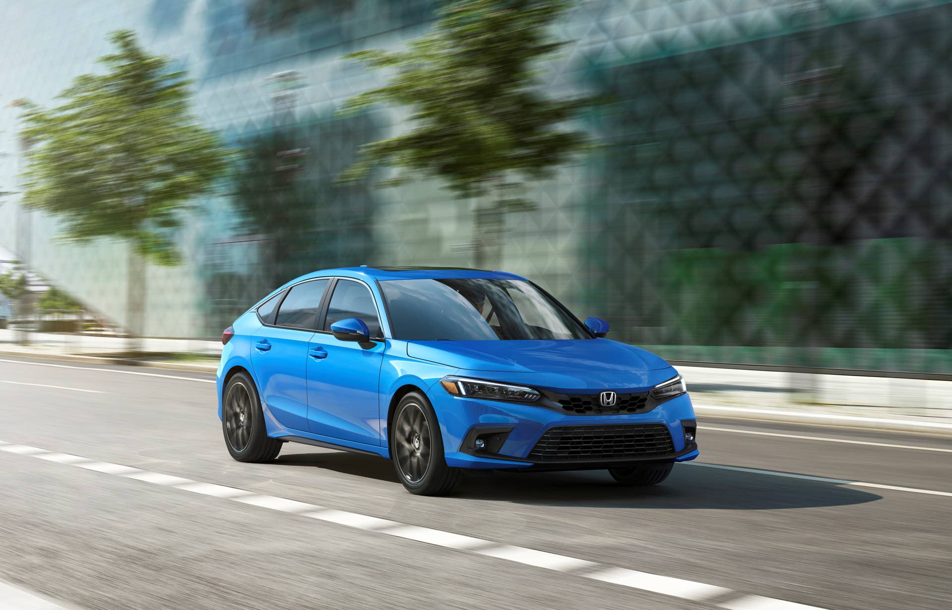 A rolling shot of a 2026 Honda Civic Hatchback Hybrid
