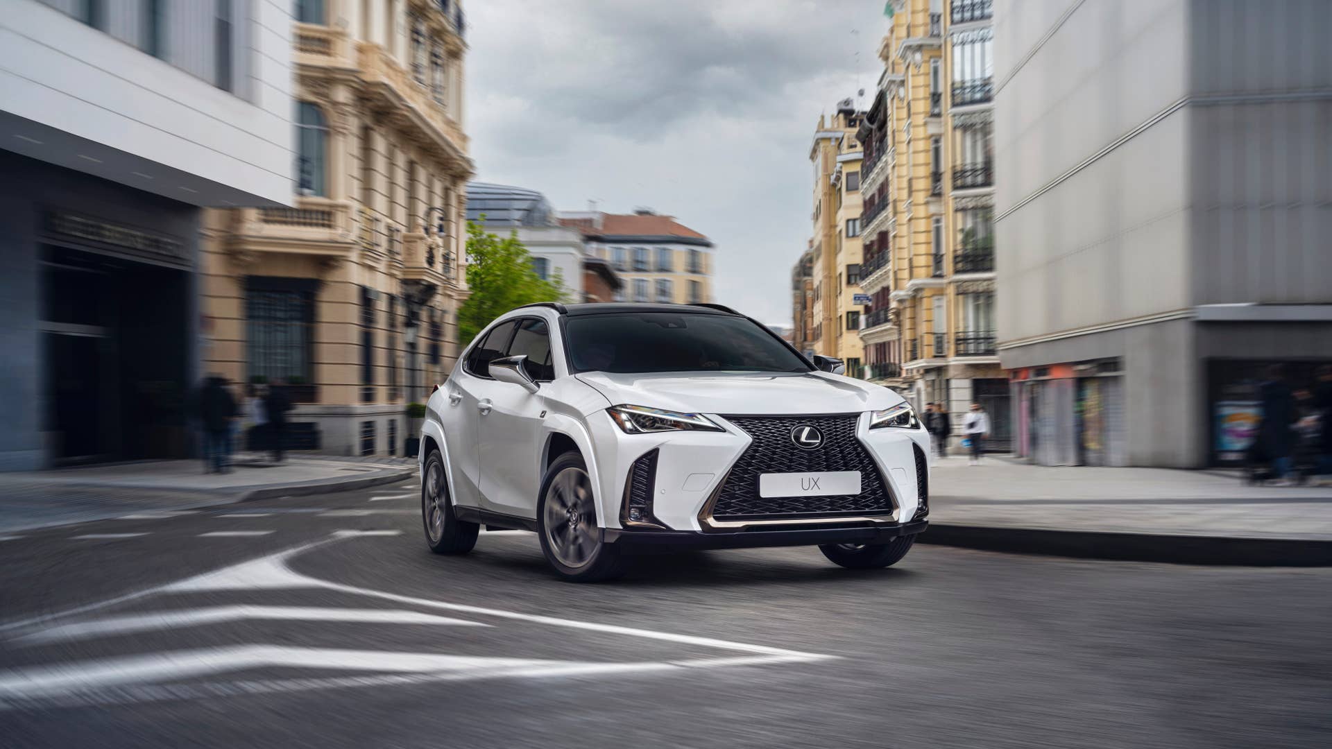 2025-2026 Lexus UXh F-Sport white front angled view driving