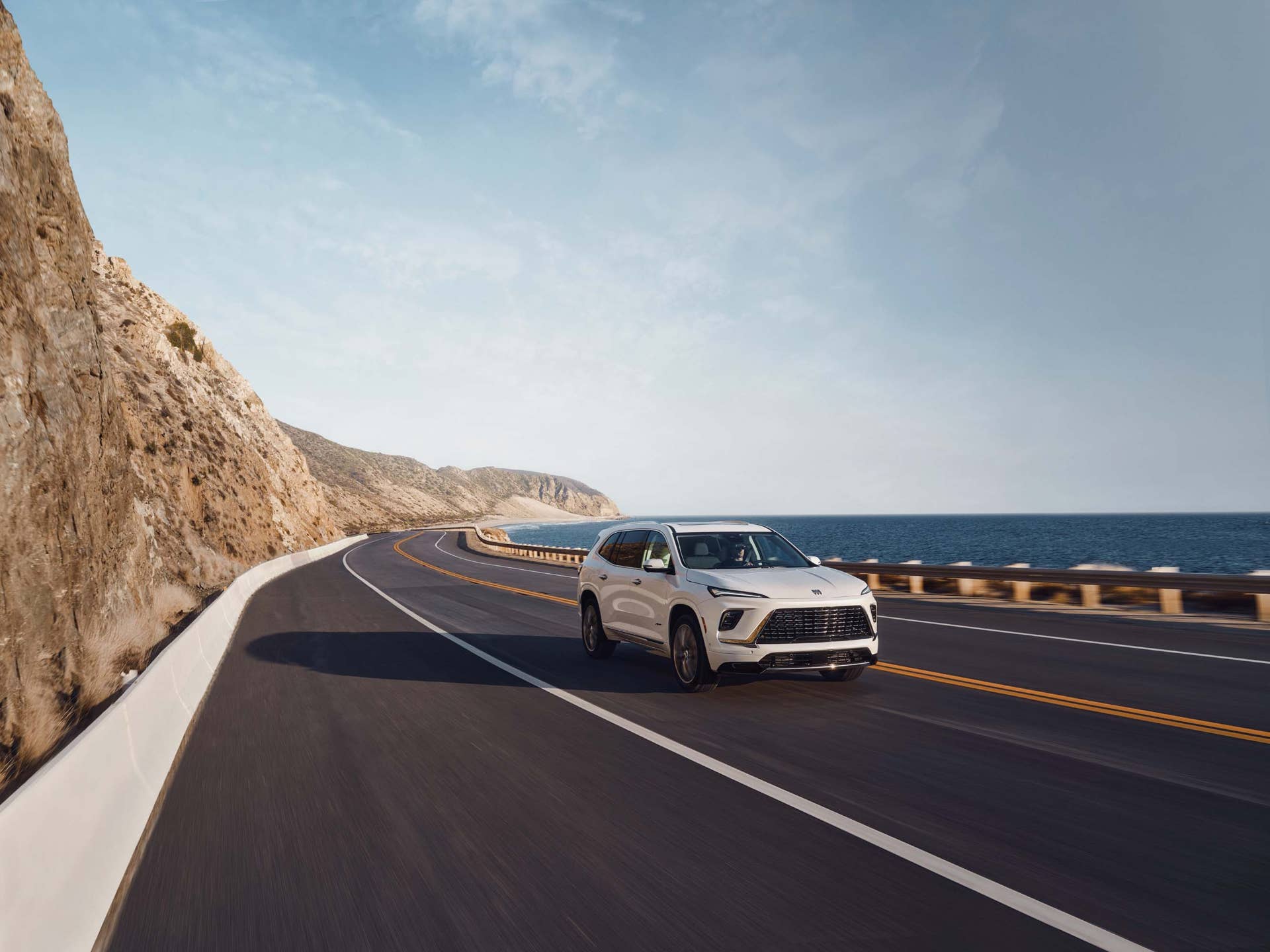2026 Buick Enclave Avenir in Iridescent White front angled view driving