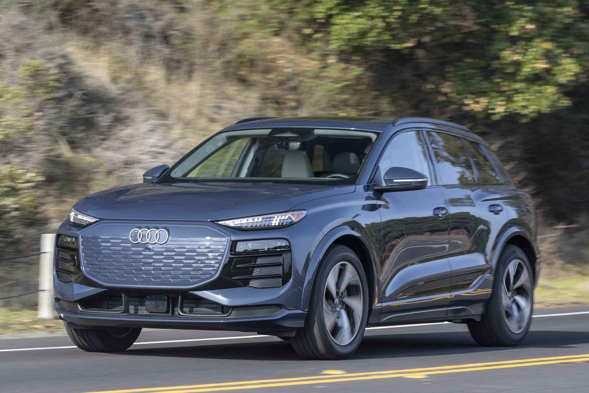 2025-2027 Audi Q6 e-tron SUV in Plasma Blue front angled view driving