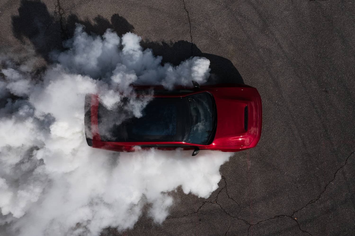 2026 Dodge Charger Scat Pack red overhead view smoky burnout