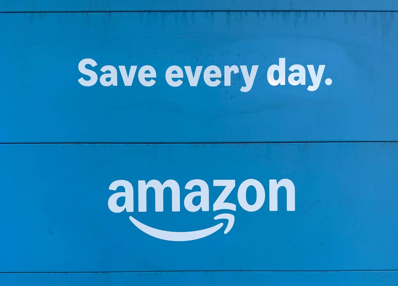 Amazon's logo and tagline on the back of an Amazon truck