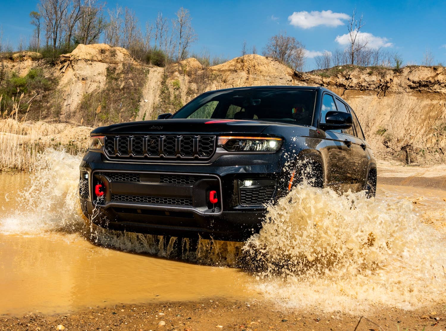 2027 Jeep® Grand Cherokee Trailhawk in black front angled view water driving