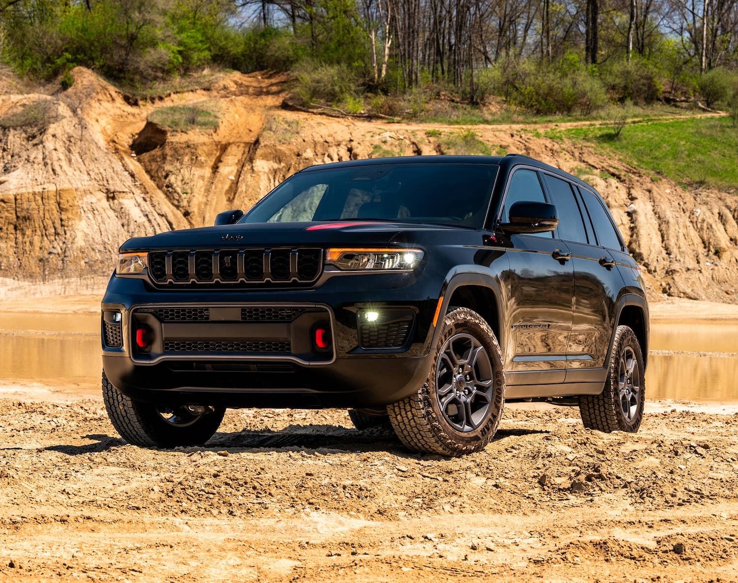 2027 Jeep® Grand Cherokee Trailhawk black front angled view off-road