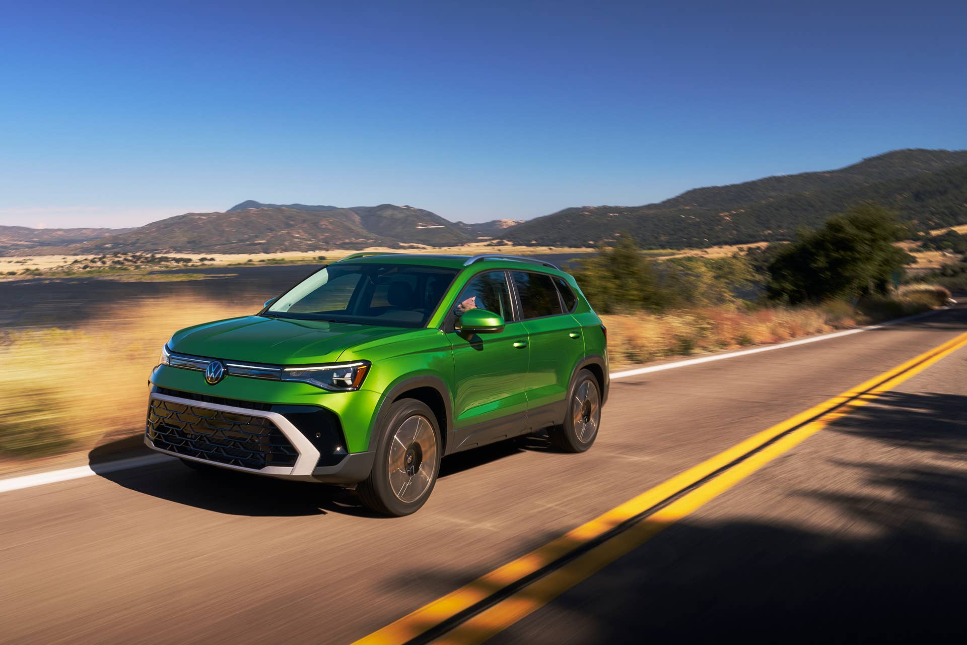 2025-2026 Volkswagen Taos in green front angled view driving