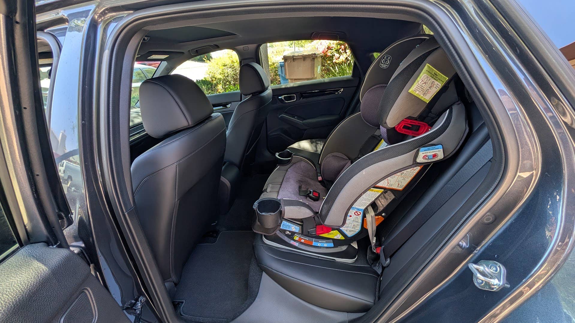 The rear seats of the 2026 Honda Civic Hatchback Hybrid with my kids' car seats installed