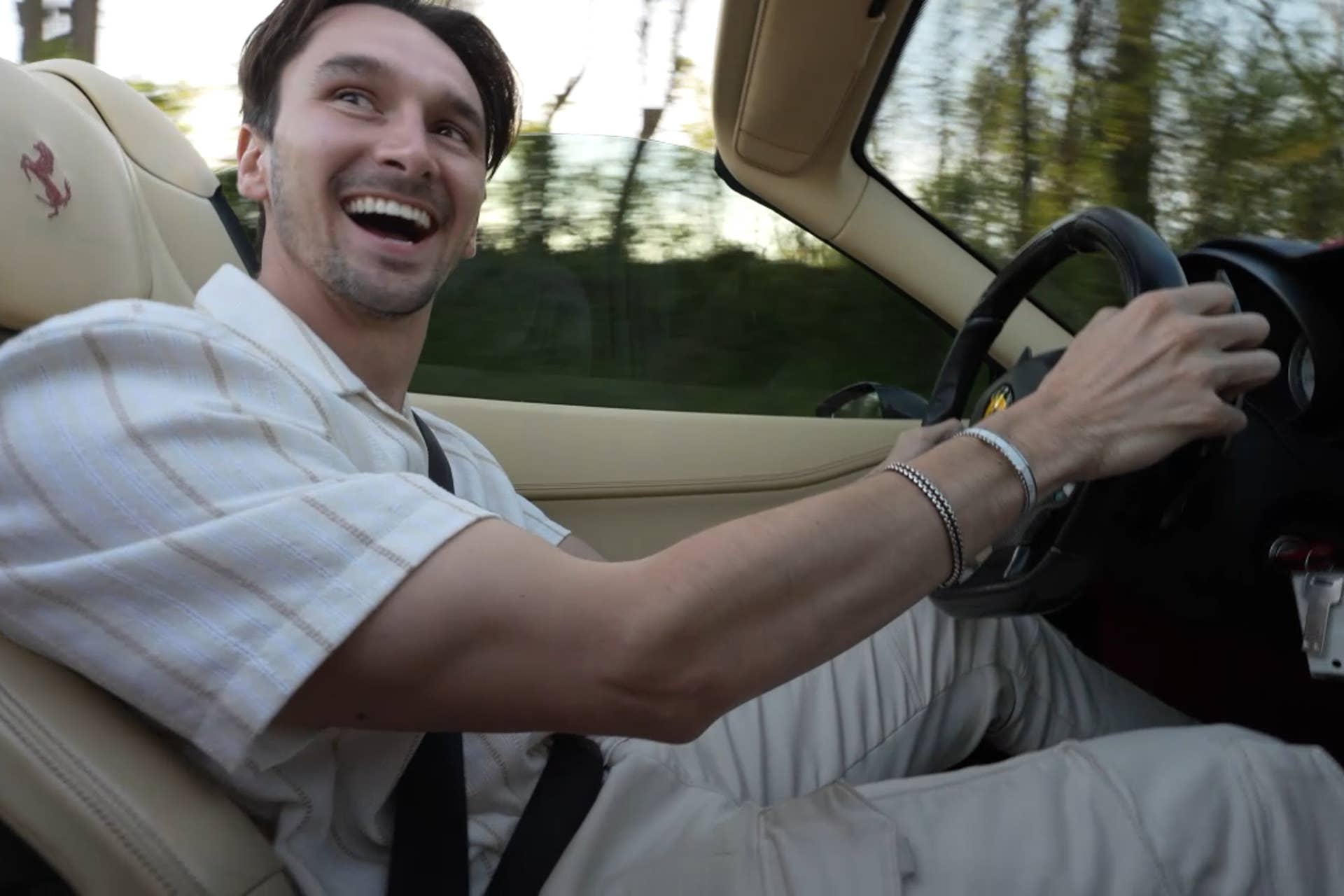 Austin Huffman behind the wheel of a Ferrari.