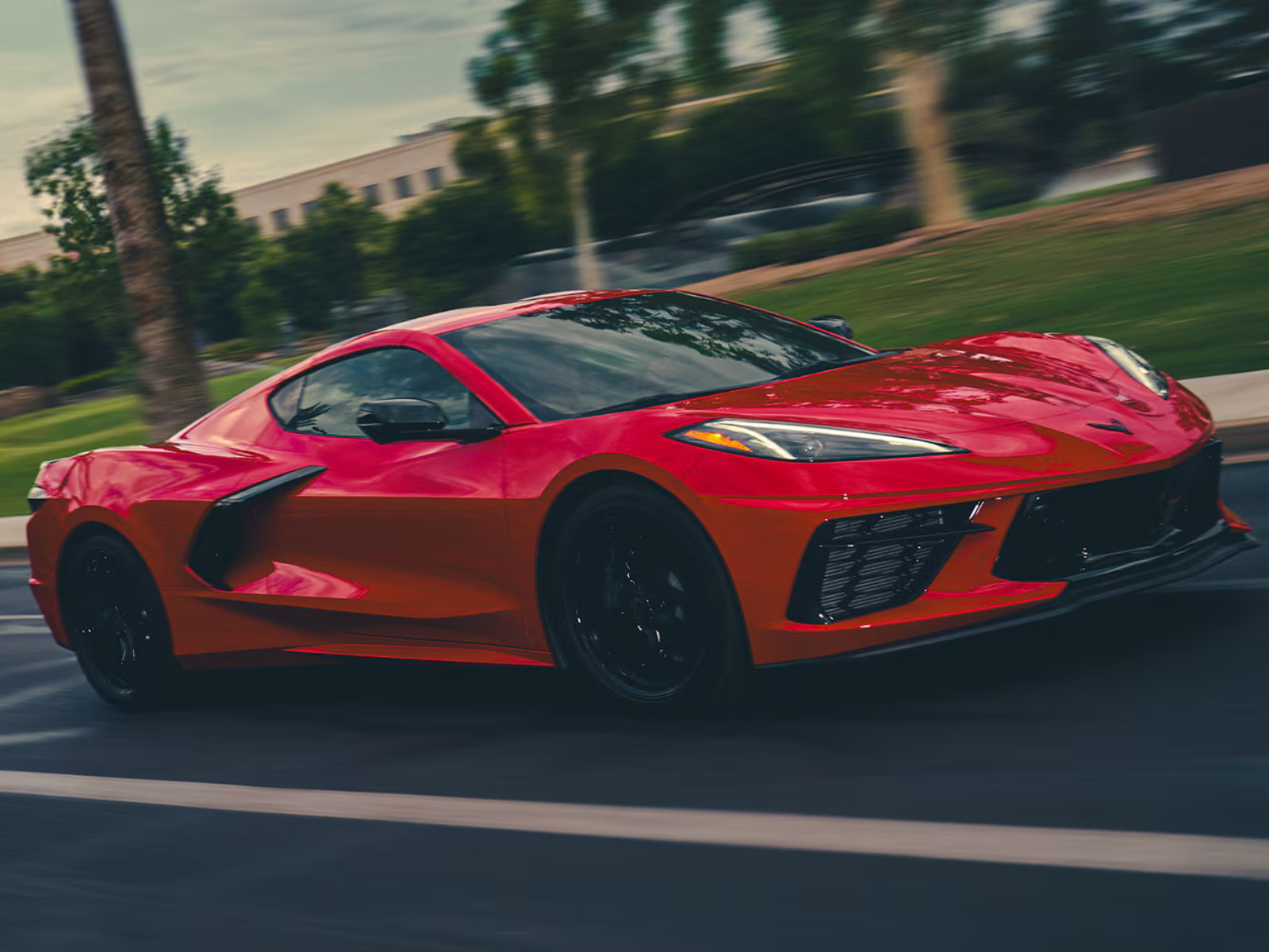 2027 Chevrolet Corvette Stingray in Red Mist Metallic Tintcoat front angled view driving
