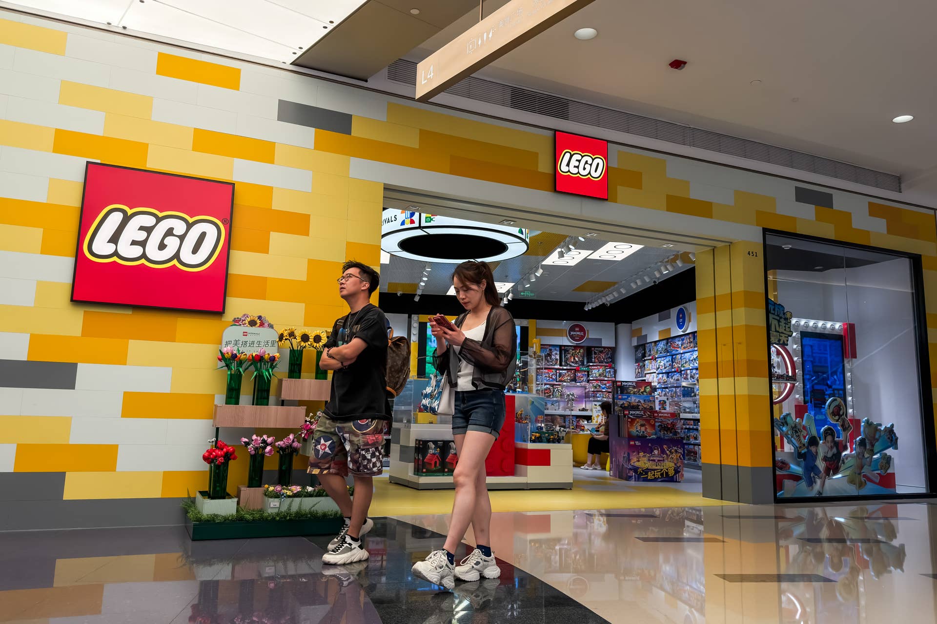 SHENZHEN, CHINA - Pedestrians walk past a LEGO retail store at a shopping mall in Shenzhen, Guangdong Province, China