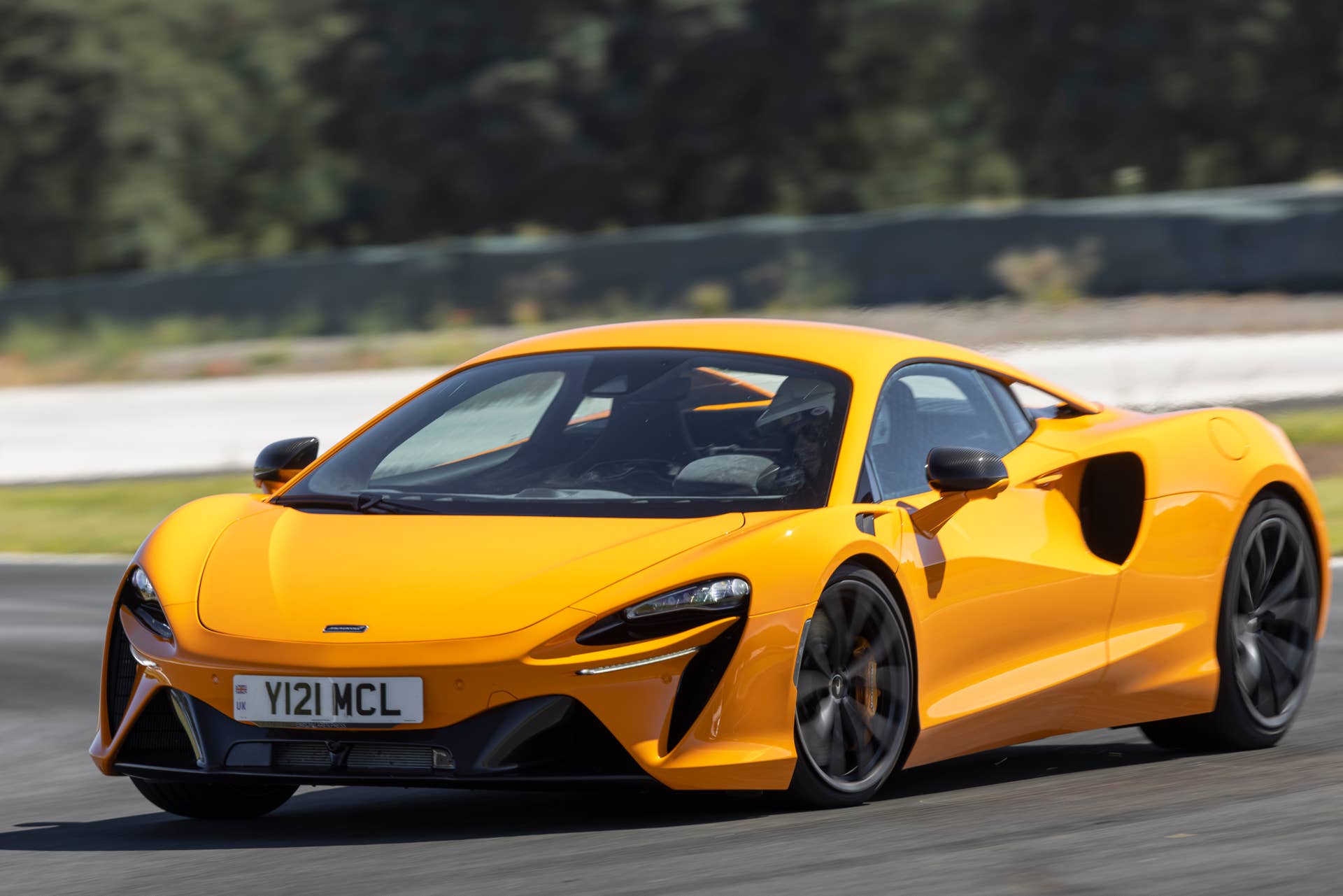 2025-2026 McLaren Artura Coupe in orange front angled view track driving