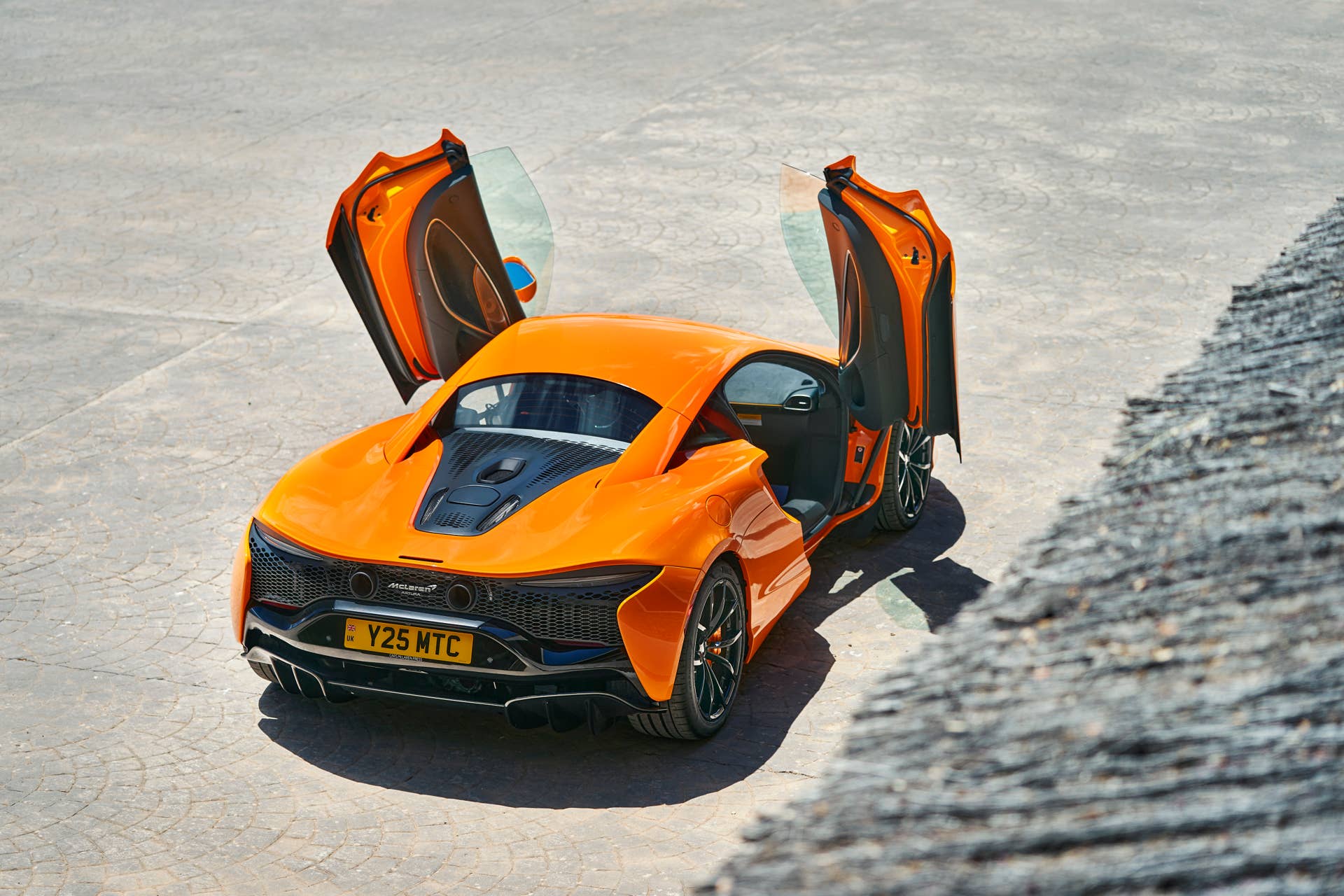 2025-2026 McLaren Artura Coupe in orange high rear angled view doors open