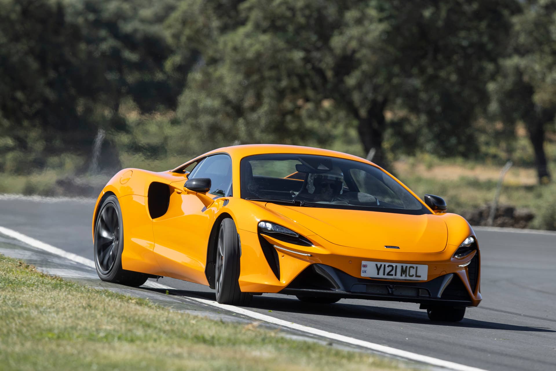 2025-2026 McLaren Artura Coupe in orange front angled view track oversteering