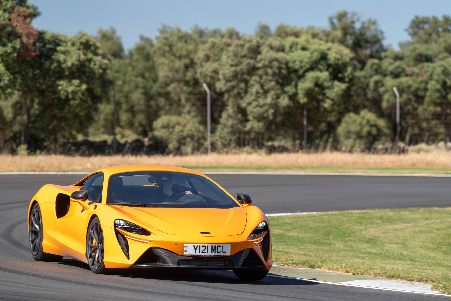 2025-2026 McLaren Artura Coupe in orange front angled view track driving