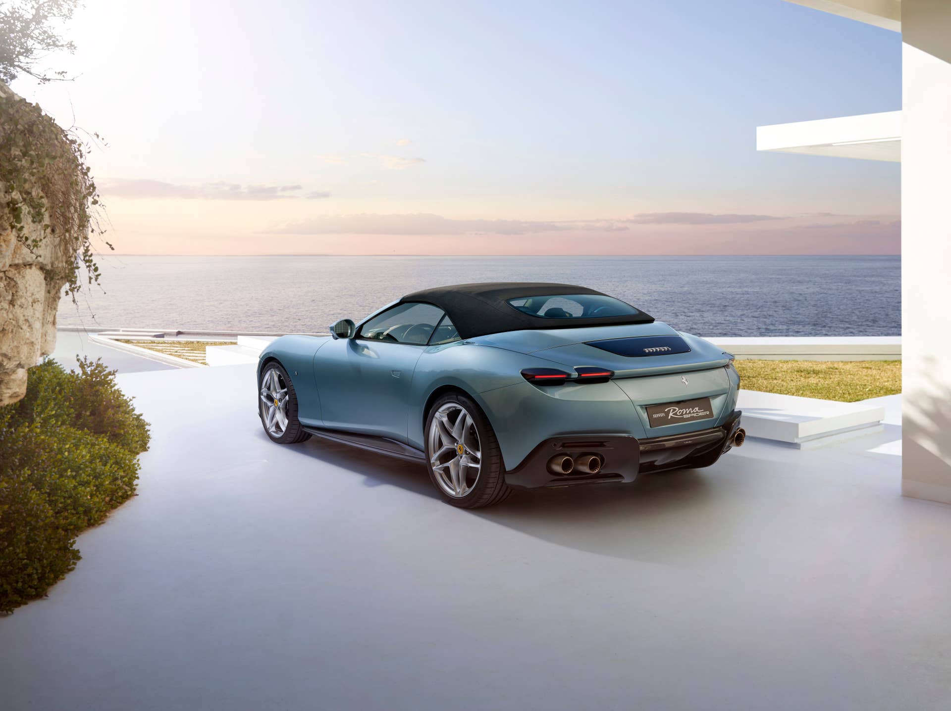 2025-2026 Ferrari Roma Spider top up in blue rear angled view