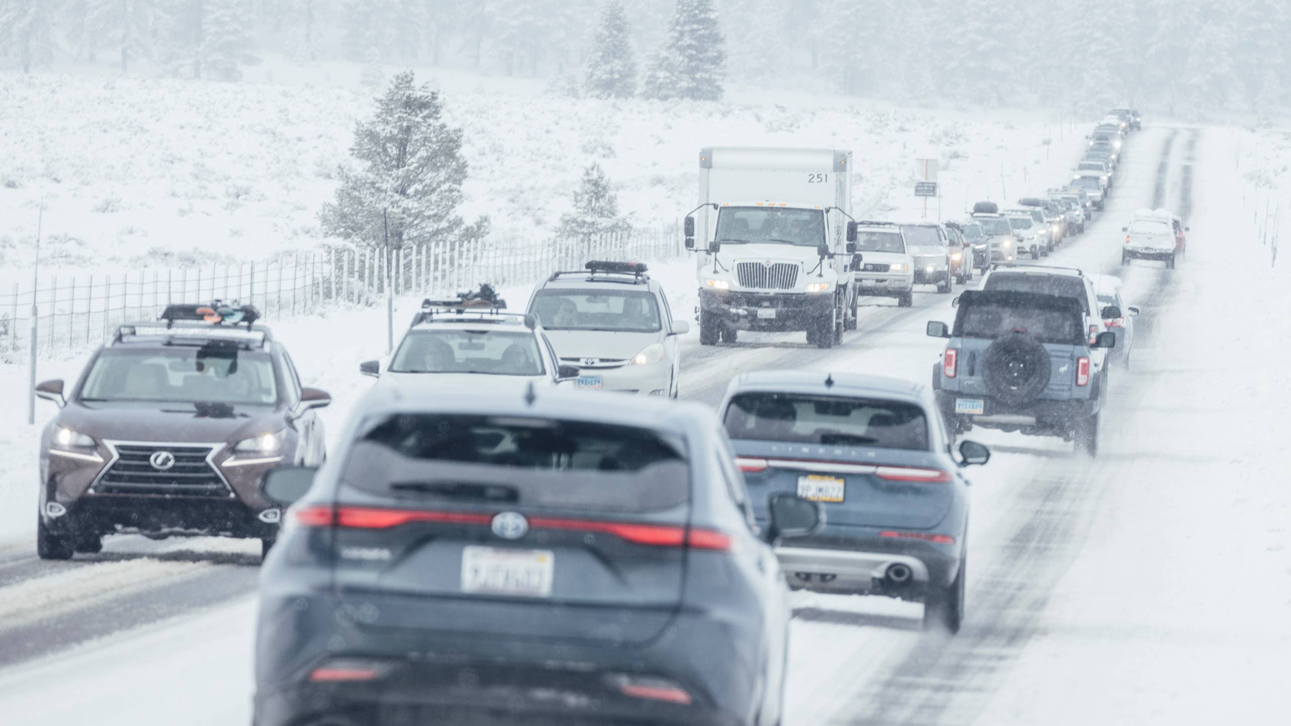Drivers drive in mountain snow covered roads
