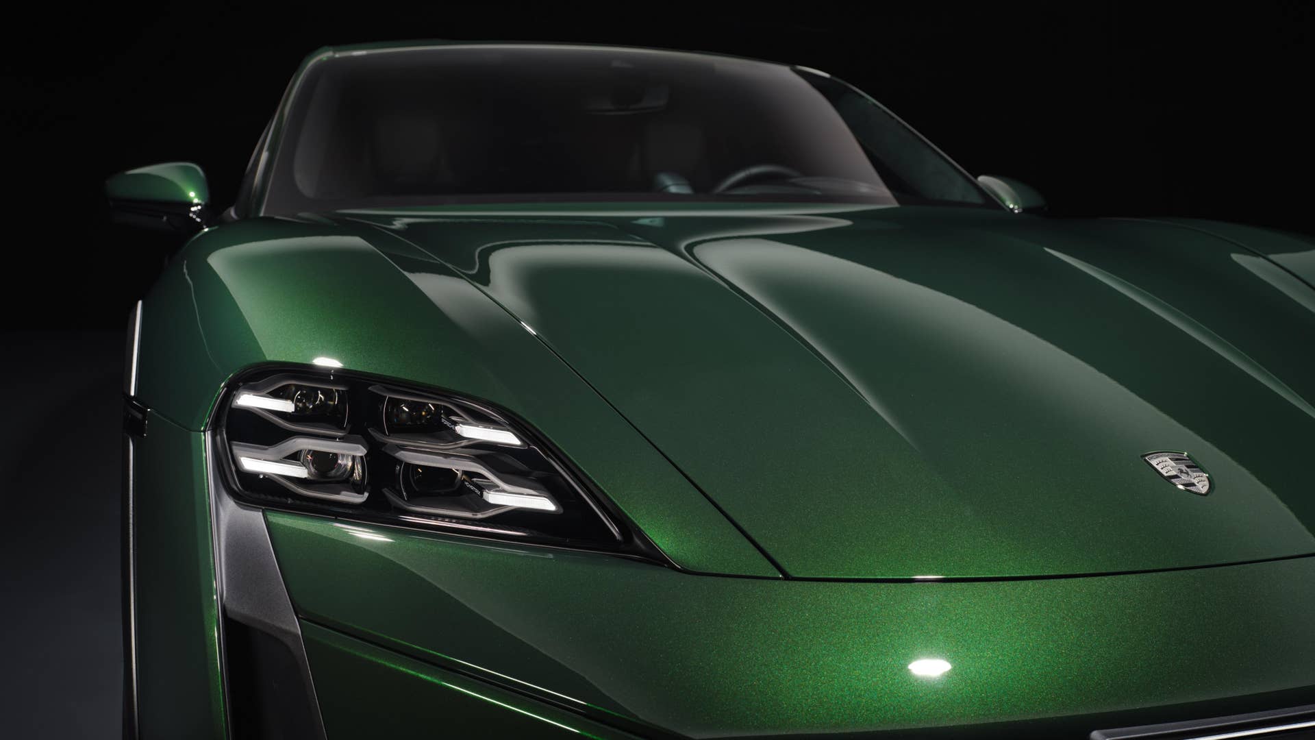 2026 Porsche Taycan Turbo Cross Turismo in green front angled view closeup