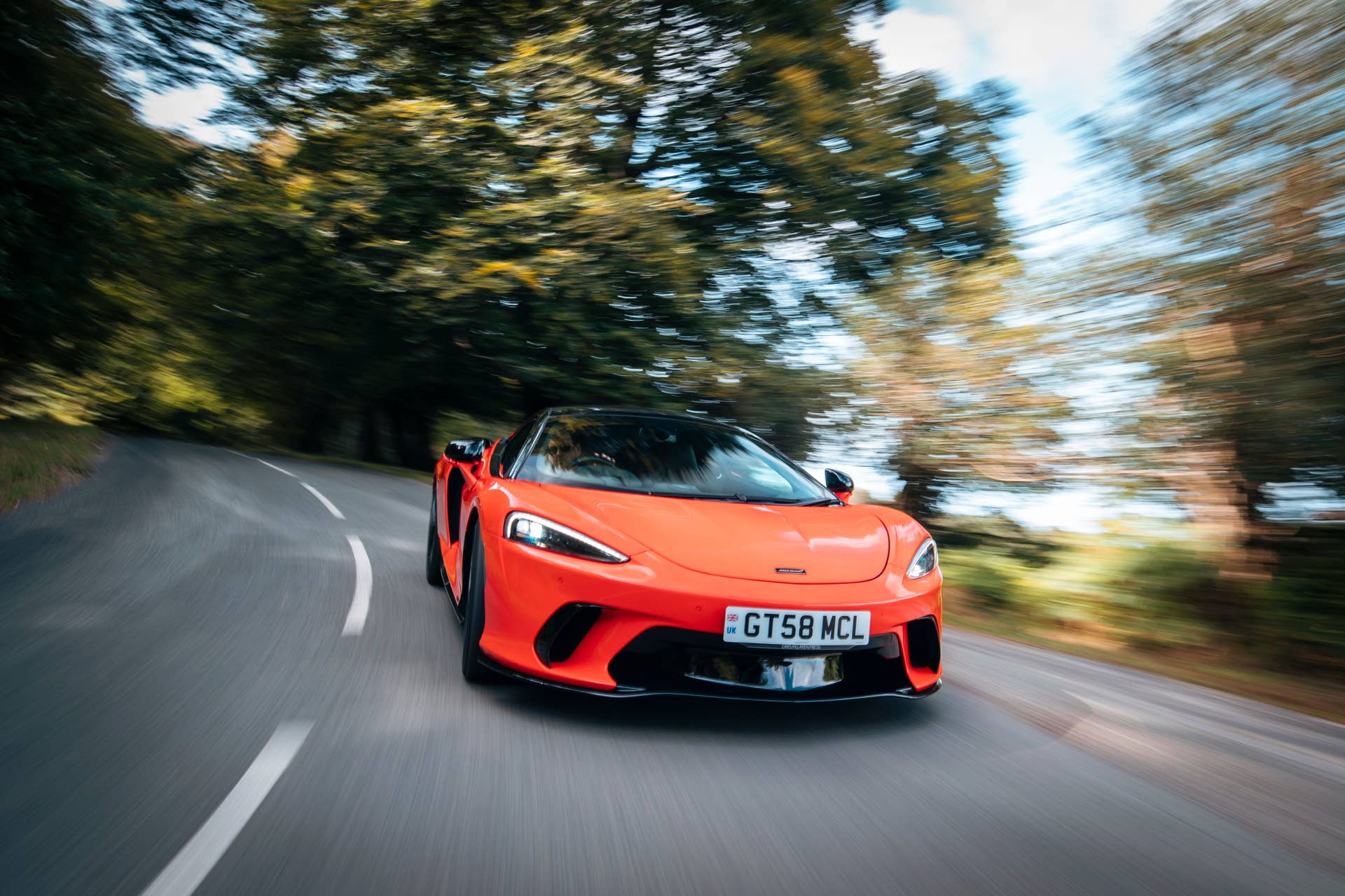 2025-2026 McLaren GTS in orange front view driving