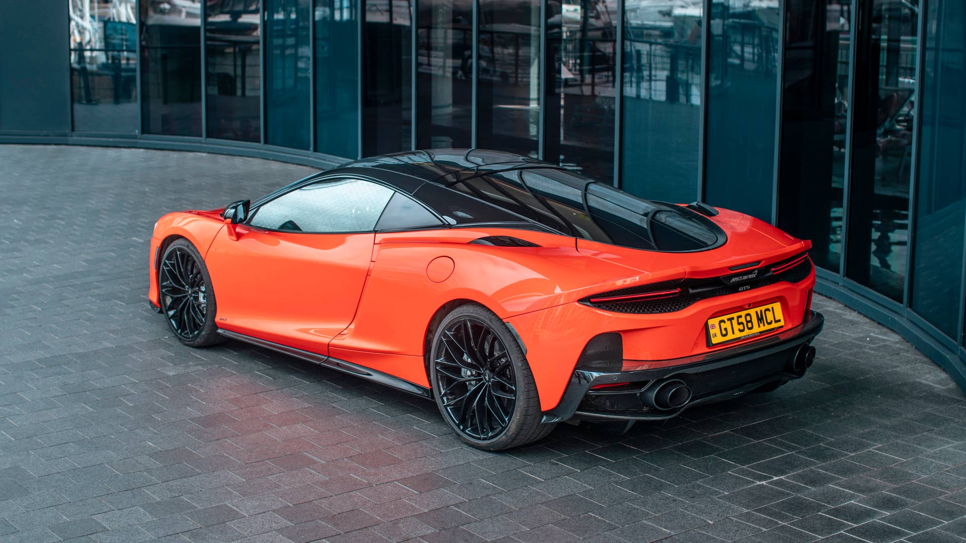 2025-2026 McLaren GTS in orange high rear angled view