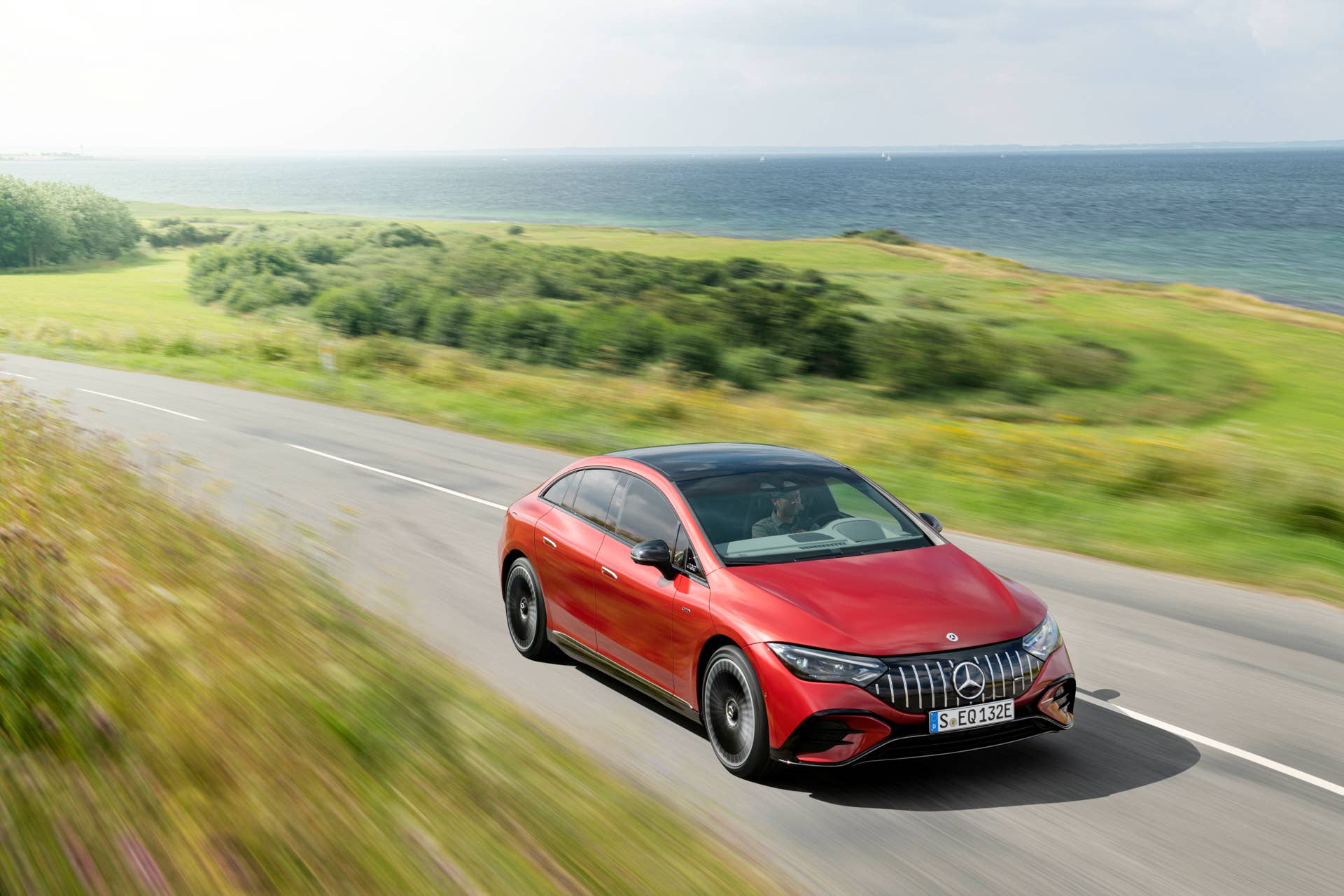 2025-2026 Mercedes-AMG EQE in red front angled view driving